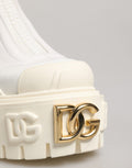 Bottines blanches en cuir et caoutchouc Dolce & Gabbana avec logo, montantes à la cheville, style élégant et moderne.