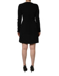 Robe courte noire Roberto Cavalli à manches longues et col en scoop, élégante et ajustée, vue de face.