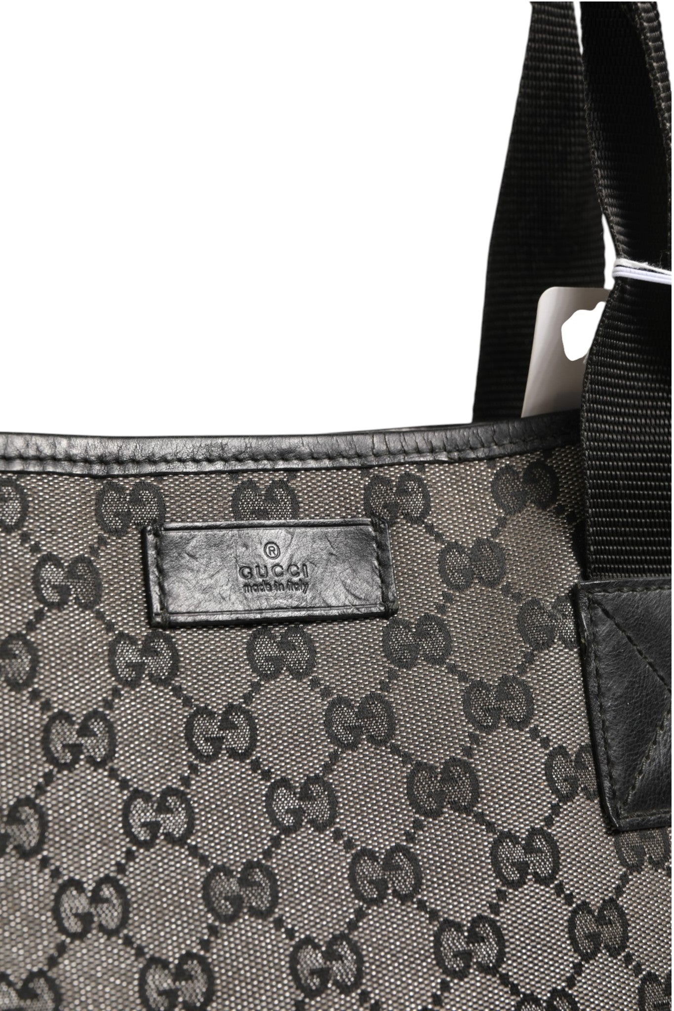 Sac shopper en toile Gucci GG, grand format, avec poignées en cuir, motif emblématique de la marque Gucci.