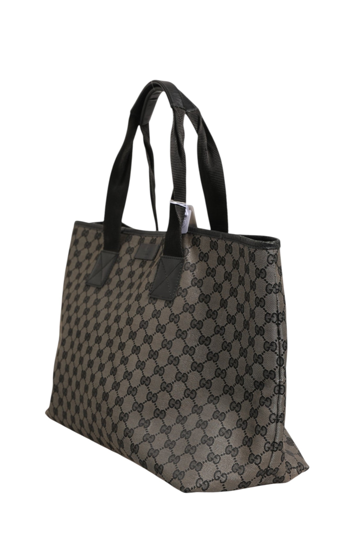 Sac cabas Gucci GG en toile avec logo emblématique, poignées en cuir et design élégant.