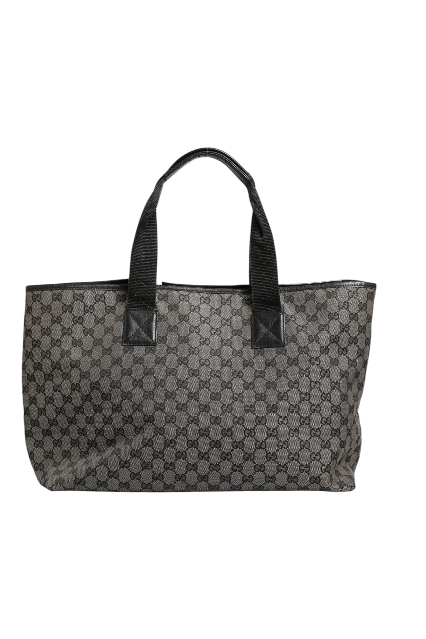 Sac Gucci GG Canvas Tote Bag en toile avec logo emblématique, porté sur l'épaule, vue de face.