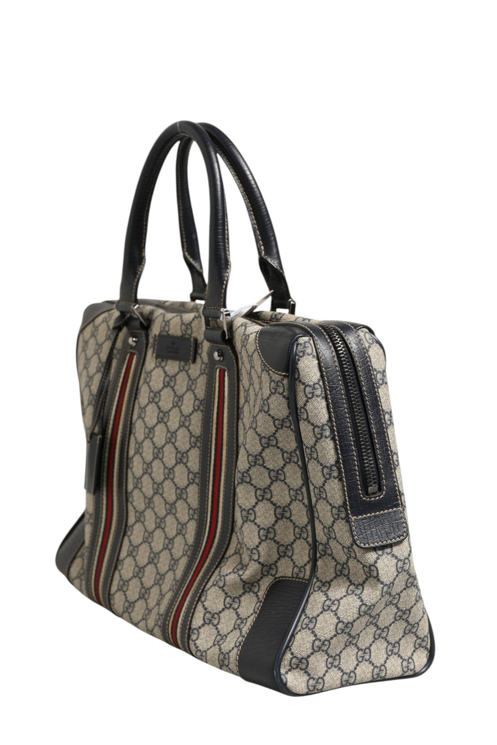 Sac à main Gucci GG Supreme Boston en toile avec poignées en cuir et logo Gucci visible.