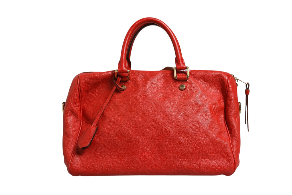 Sac à main Louis Vuitton Speedy Bandoulière 30 en Monogram Empreinte rouge, avec bandoulière et détails en cuir naturel.