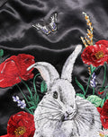 Veste bomber en satin noir Dolce & Gabbana avec broderie florale élégante et détails sophistiqués.