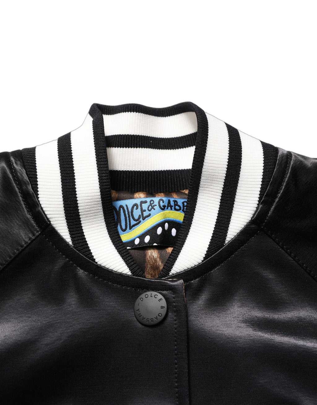 Veste bomber en satin noir Dolce & Gabbana avec broderie florale élégante et détails sophistiqués.