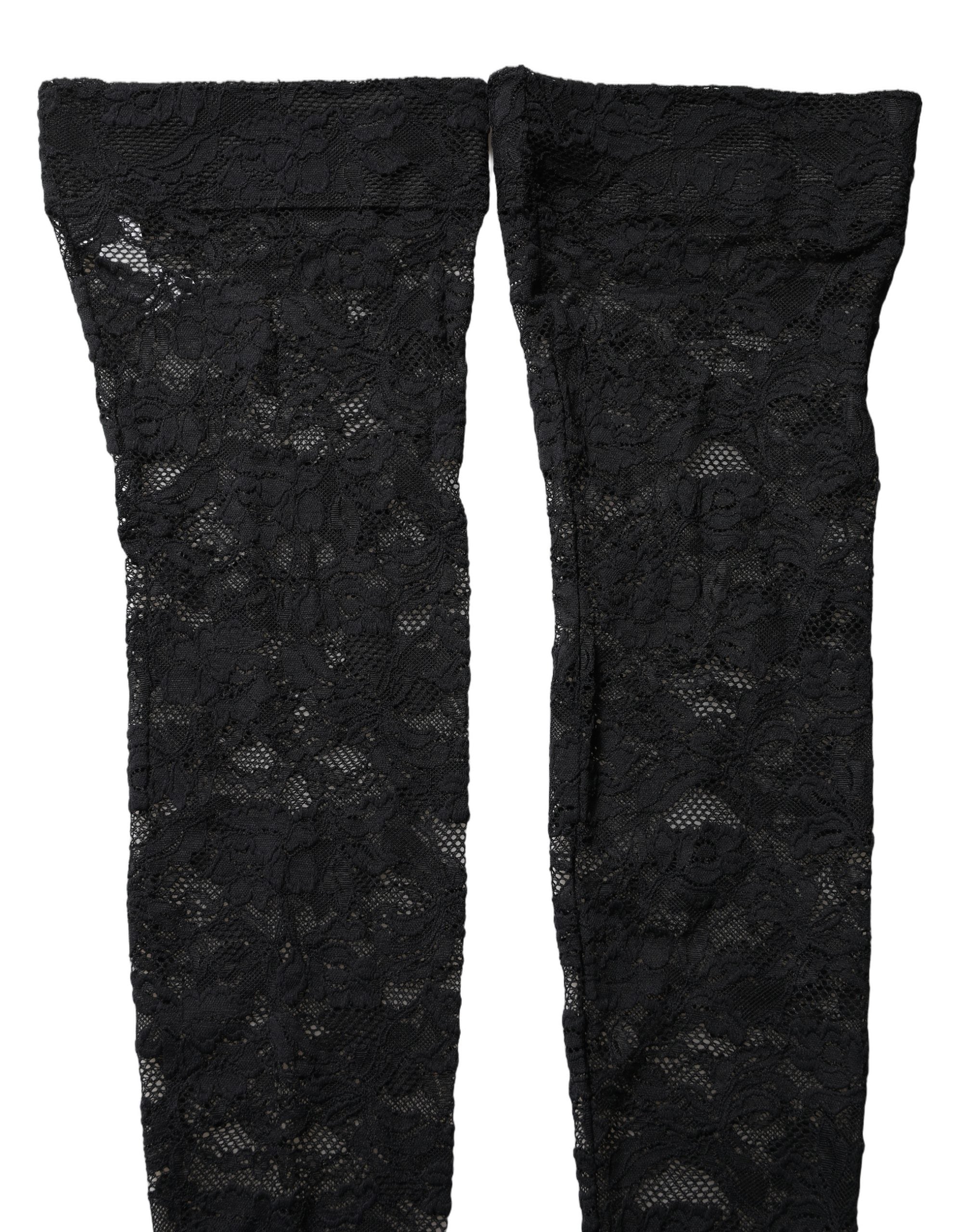 Chaussettes hautes en dentelle florale noire de Dolce & Gabbana, élégantes et sophistiquées, visibles sur la jambe.