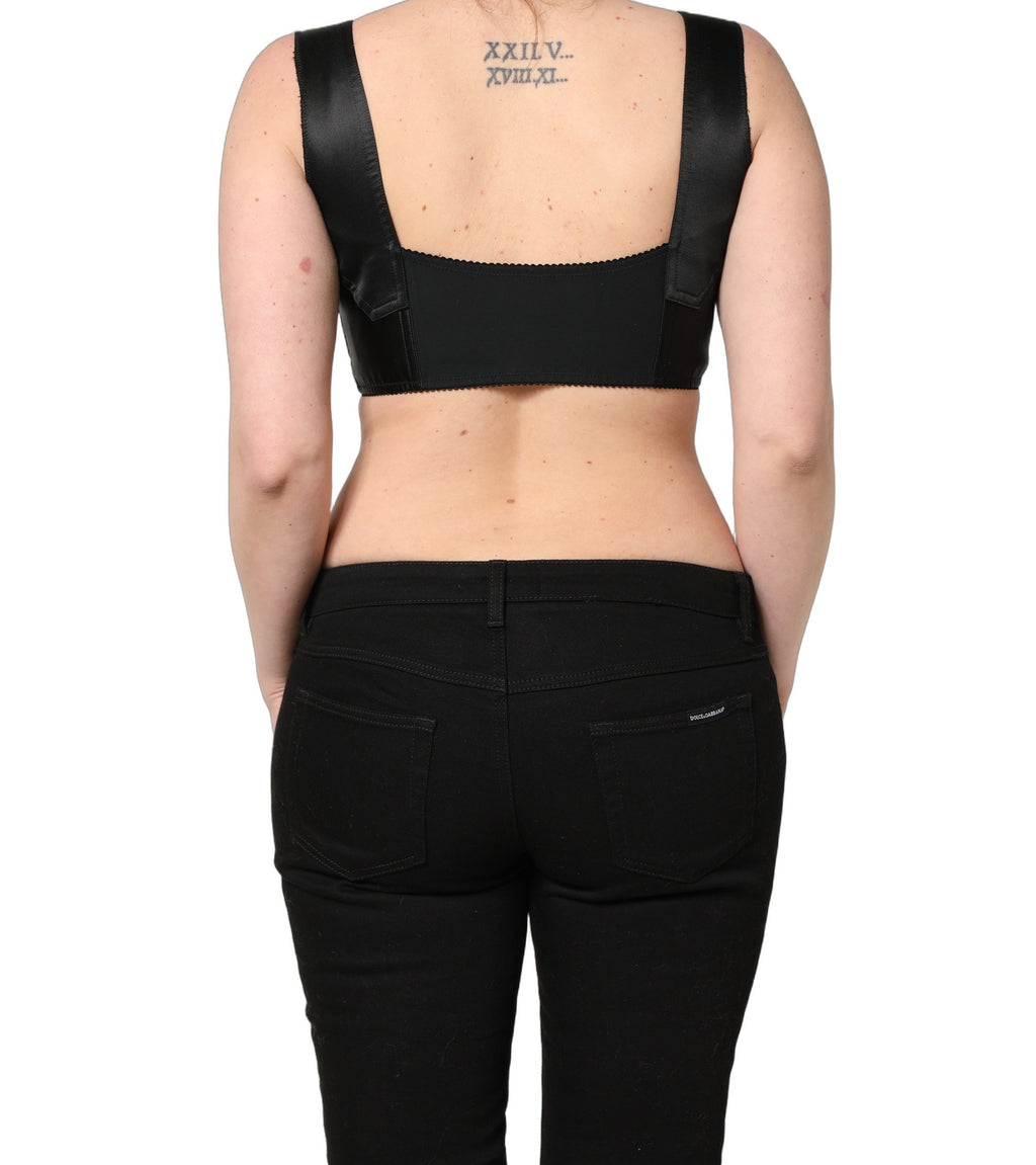 Corset noir en satin et nylon Dolce & Gabbana sans manches, haut court et ajusté, avec détails élégants.