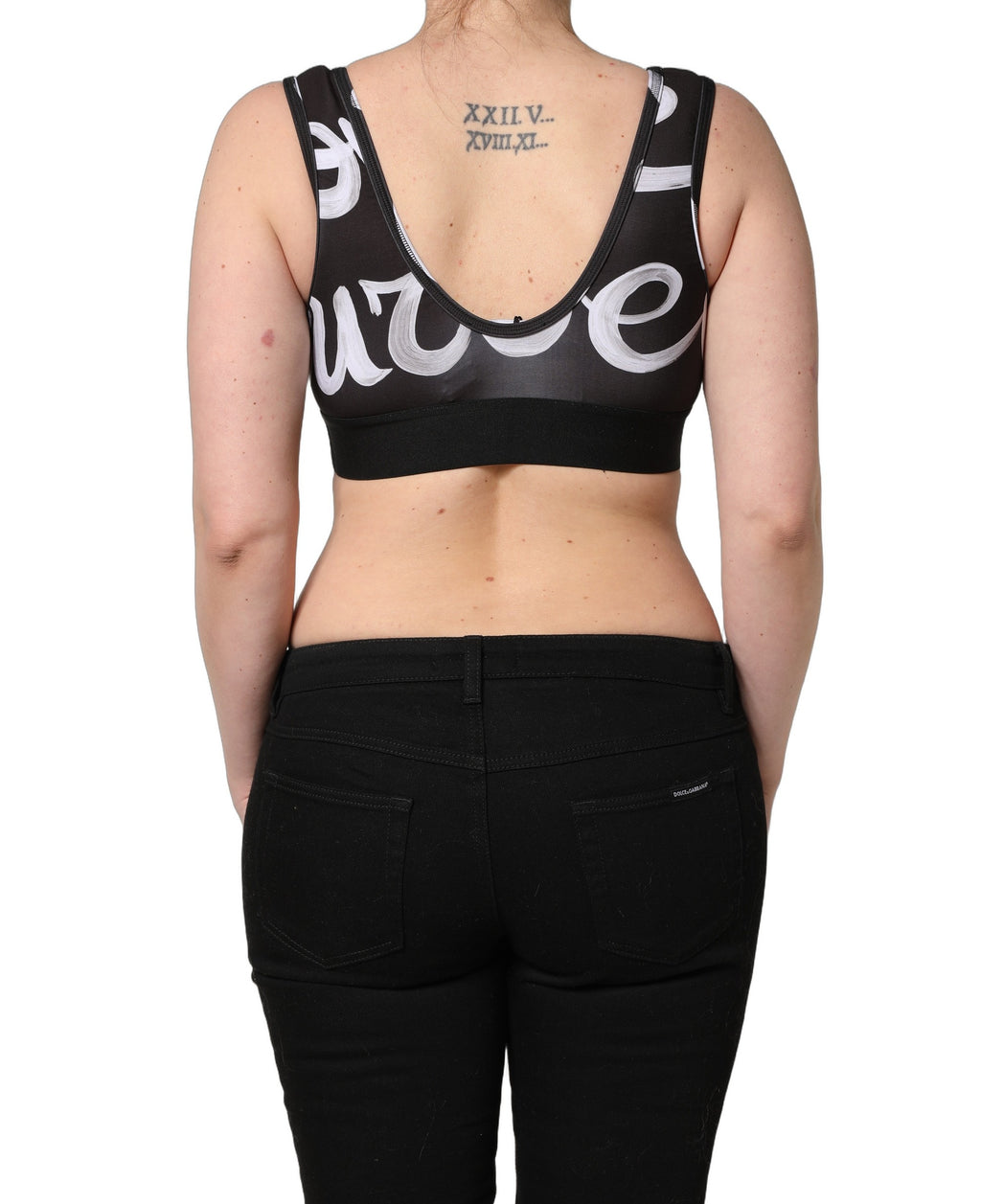 Brassière de sport noire Dolce & Gabbana DG Love Yourself, haut court en tissu extensible avec logo brodé.