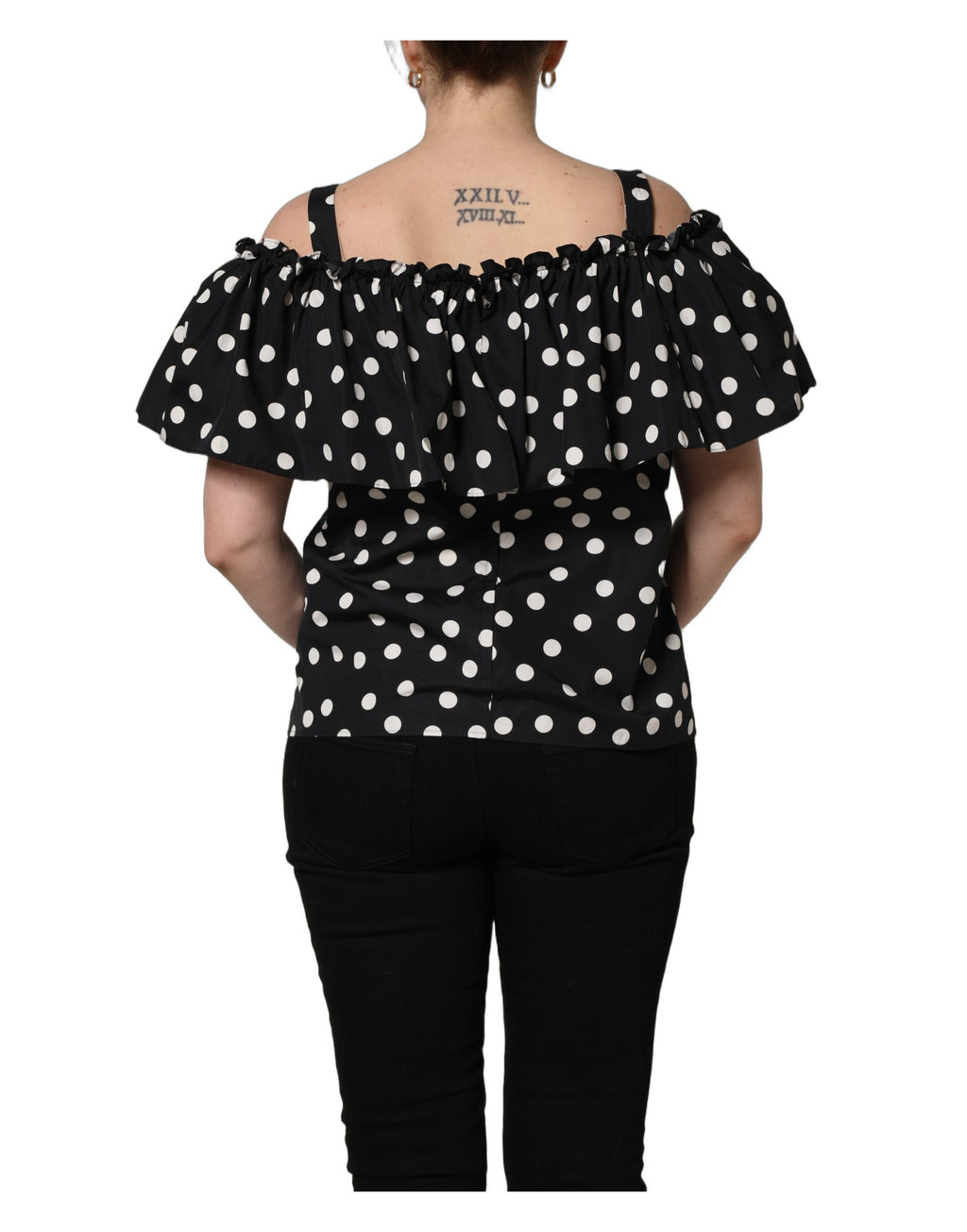 Haut noir et blanc à pois Dolce & Gabbana, décolleté en off-shoulder avec manches longues, élégance sophistiquée.