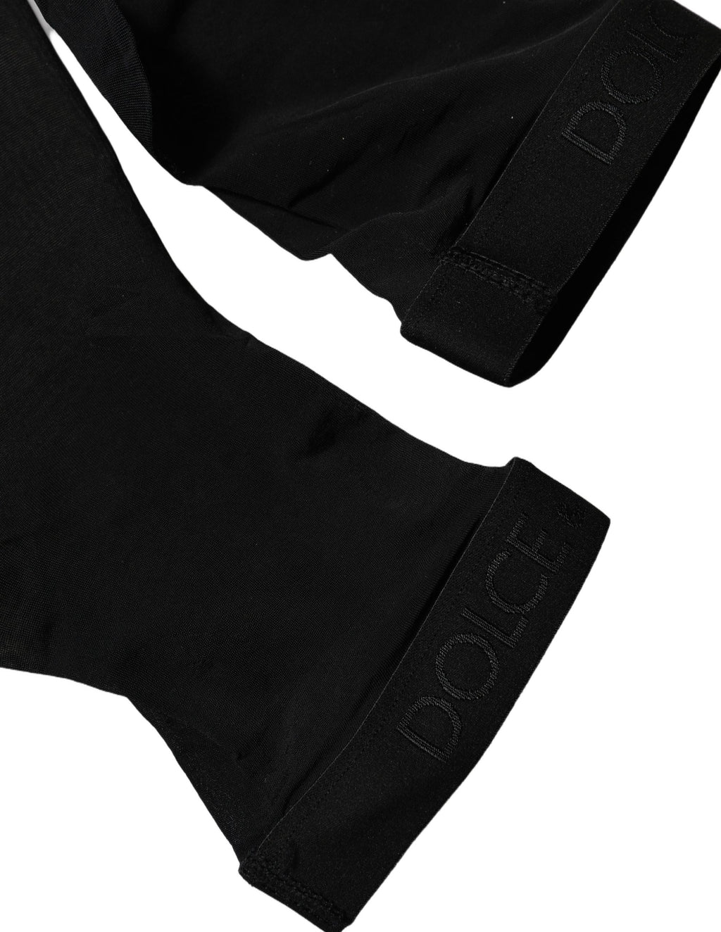 Chaussettes noires en nylon transparent de la marque Dolce & Gabbana, mi-thigh, style élégant et sexy, visibles en détail dans l’image.