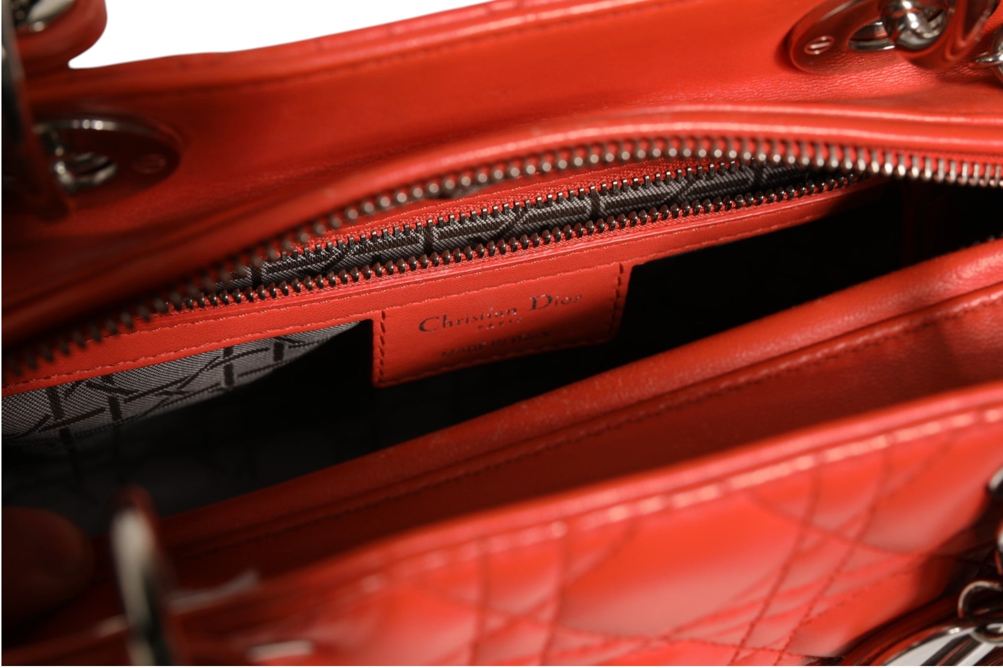 Sac à main Lady Dior en cuir de veau orange avec motif cannage de la marque Christian Dior.
