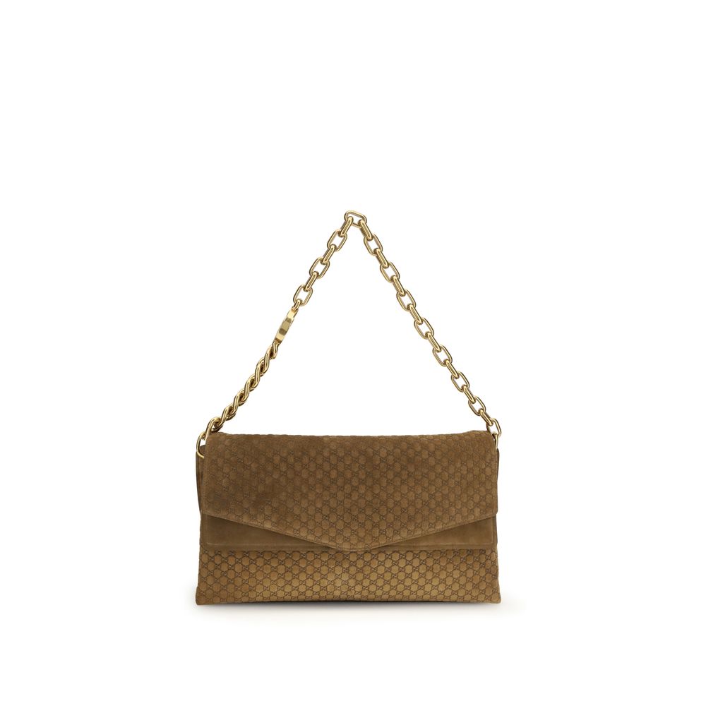 Sac à main Gucci en cuir suédé marron, élégant et sophistiqué, avec détails en or et poignée robuste.