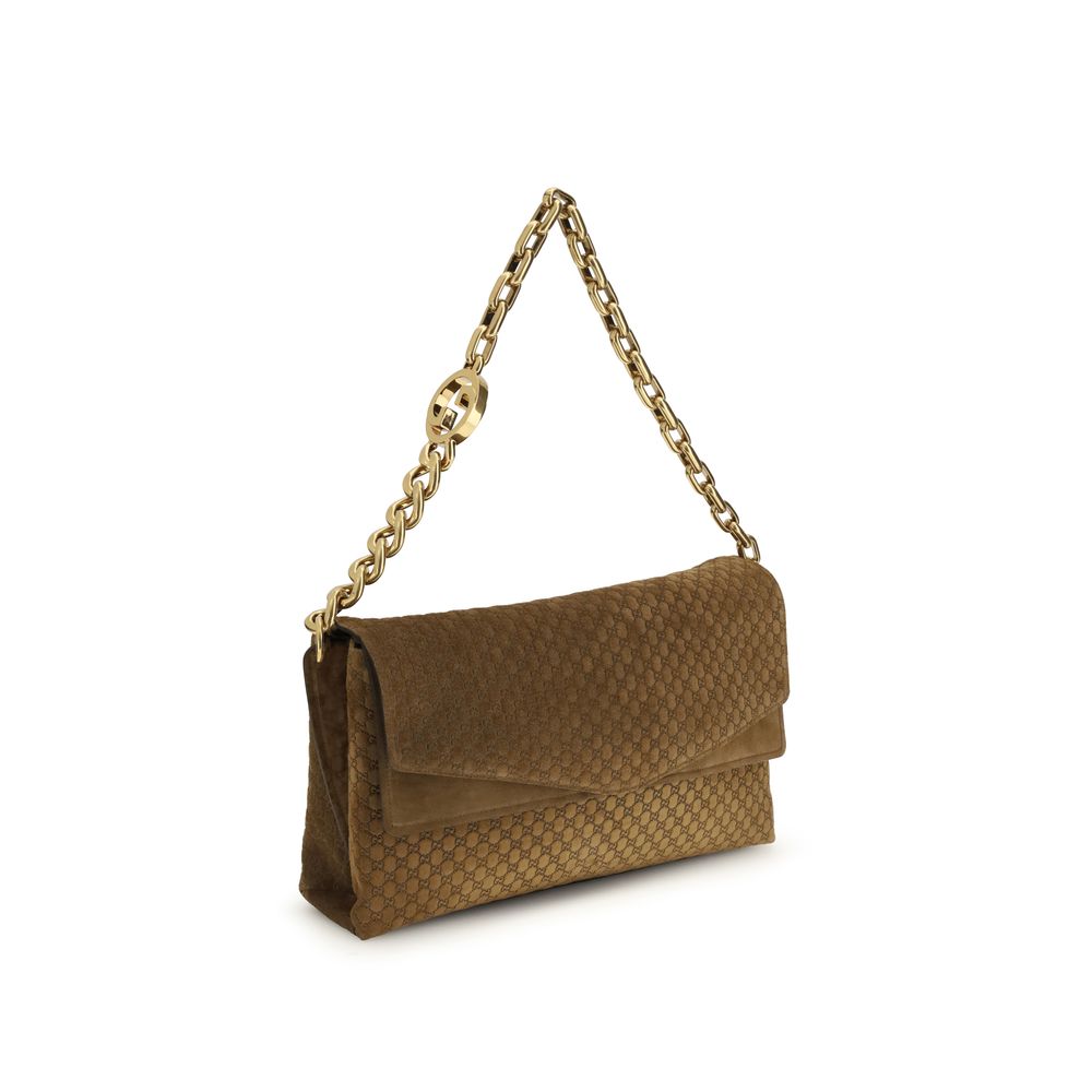 Sac à main en cuir et daim marron Gucci, style élégant avec détails sophistiqués, vue de face montrant la poignée et la fermeture