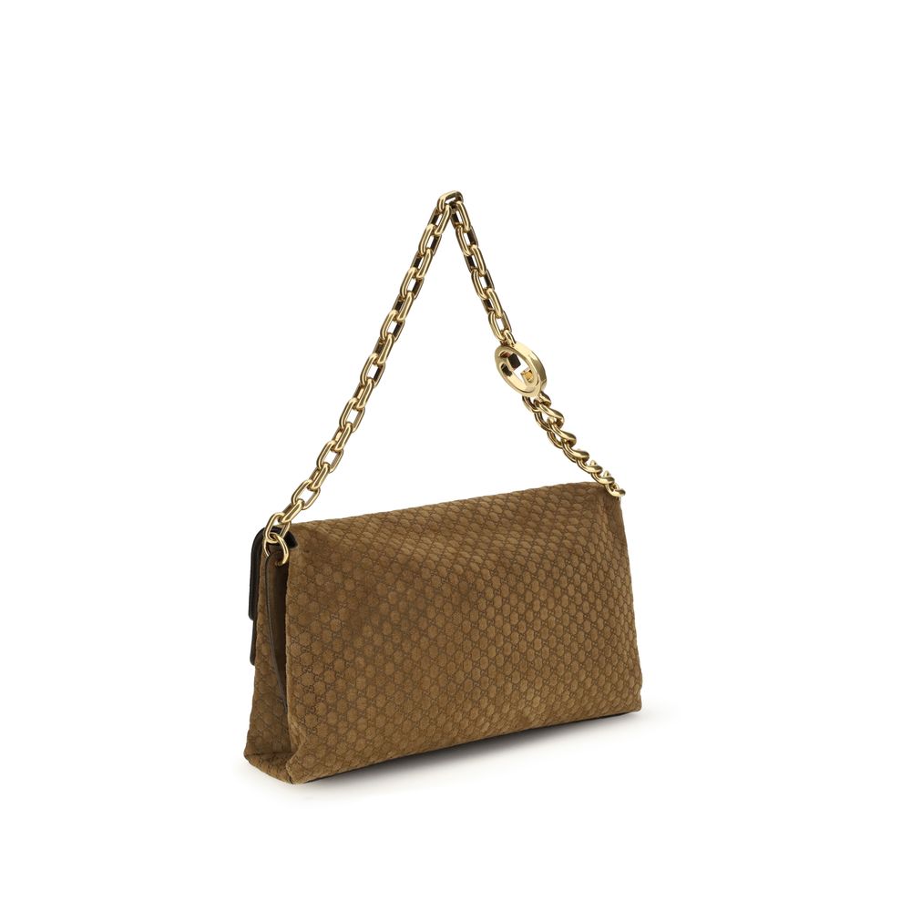 Sac à main en cuir suédé marron Gucci, élégant et tendance, avec détails raffinés visibles sur l'image.