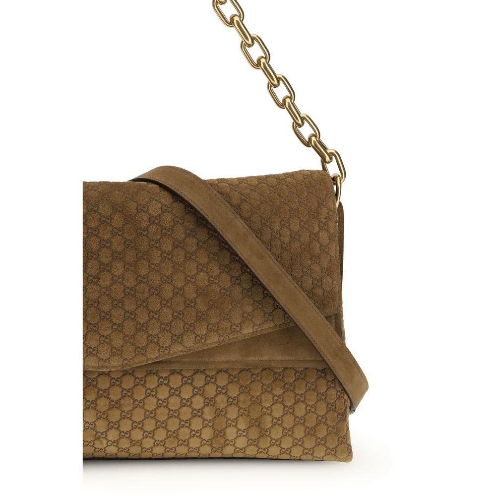 Sac à main en cuir suédé marron Gucci, élégant, avec détails raffinés visibles sur l'image.