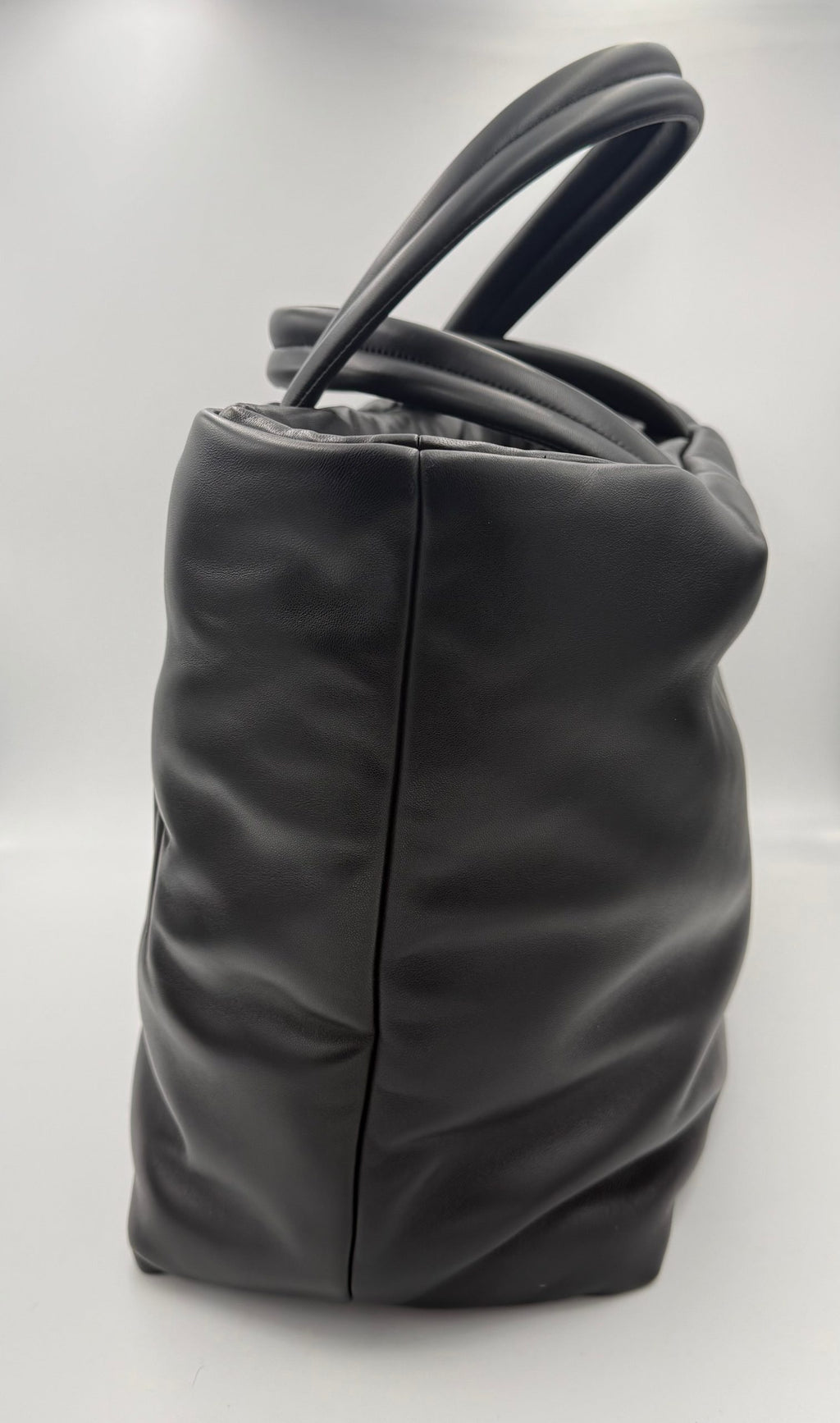 Grand sac shopping Saint Laurent en cuir de mouton, design élégant et sophistiqué, avec logo Saint Laurent visible.