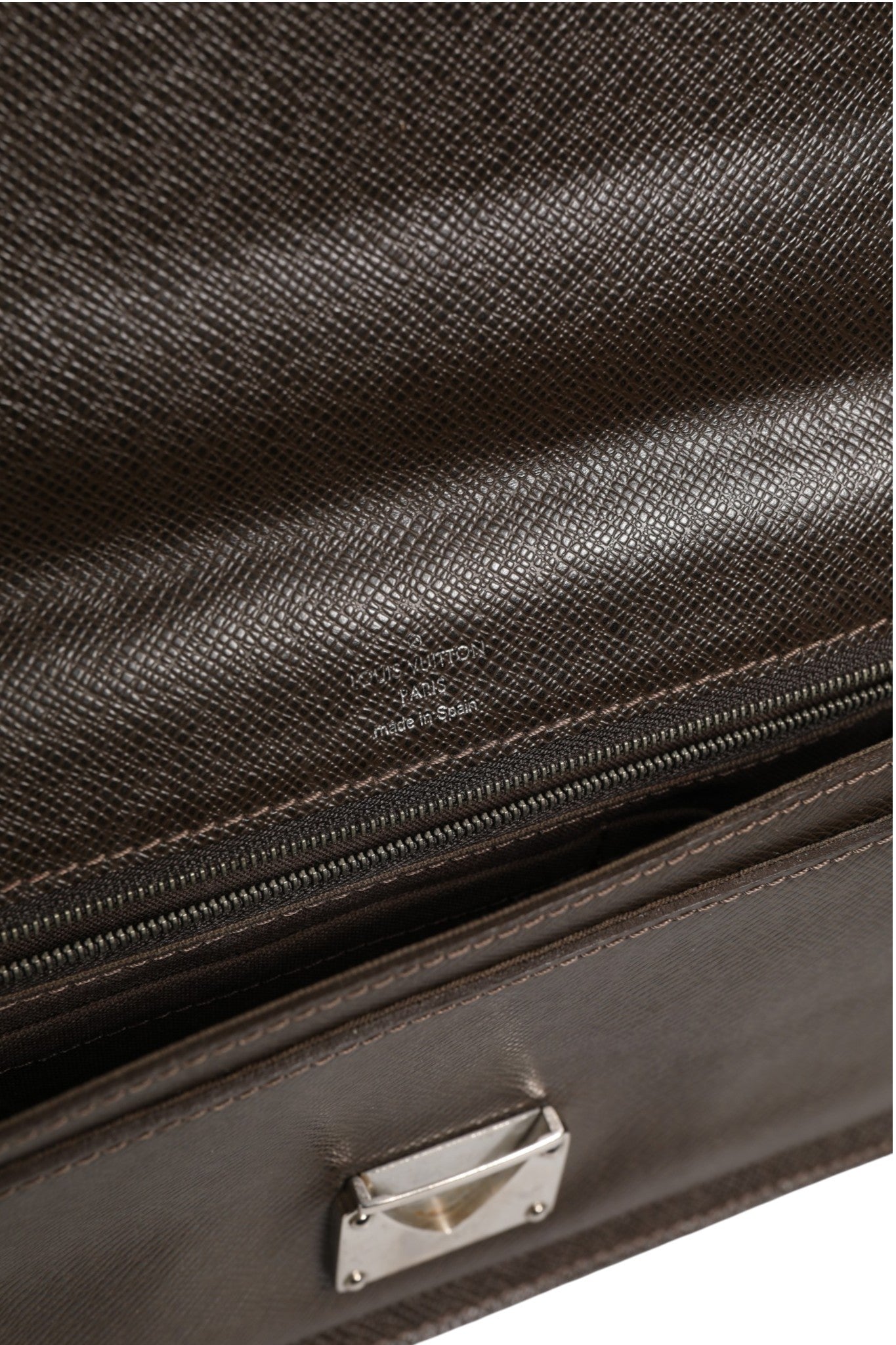 Pochette Louis Vuitton Belaia en cuir Taiga marron avec fermeture éclair et intérieur spacieux, élégante et sophistiquée.