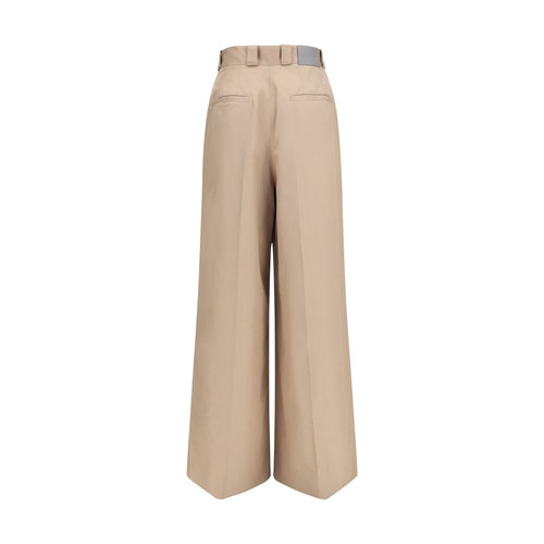 Pantalons évasés en coton beige de Balenciaga, coupe fluide et élégante, affichés sur un fond neutre.