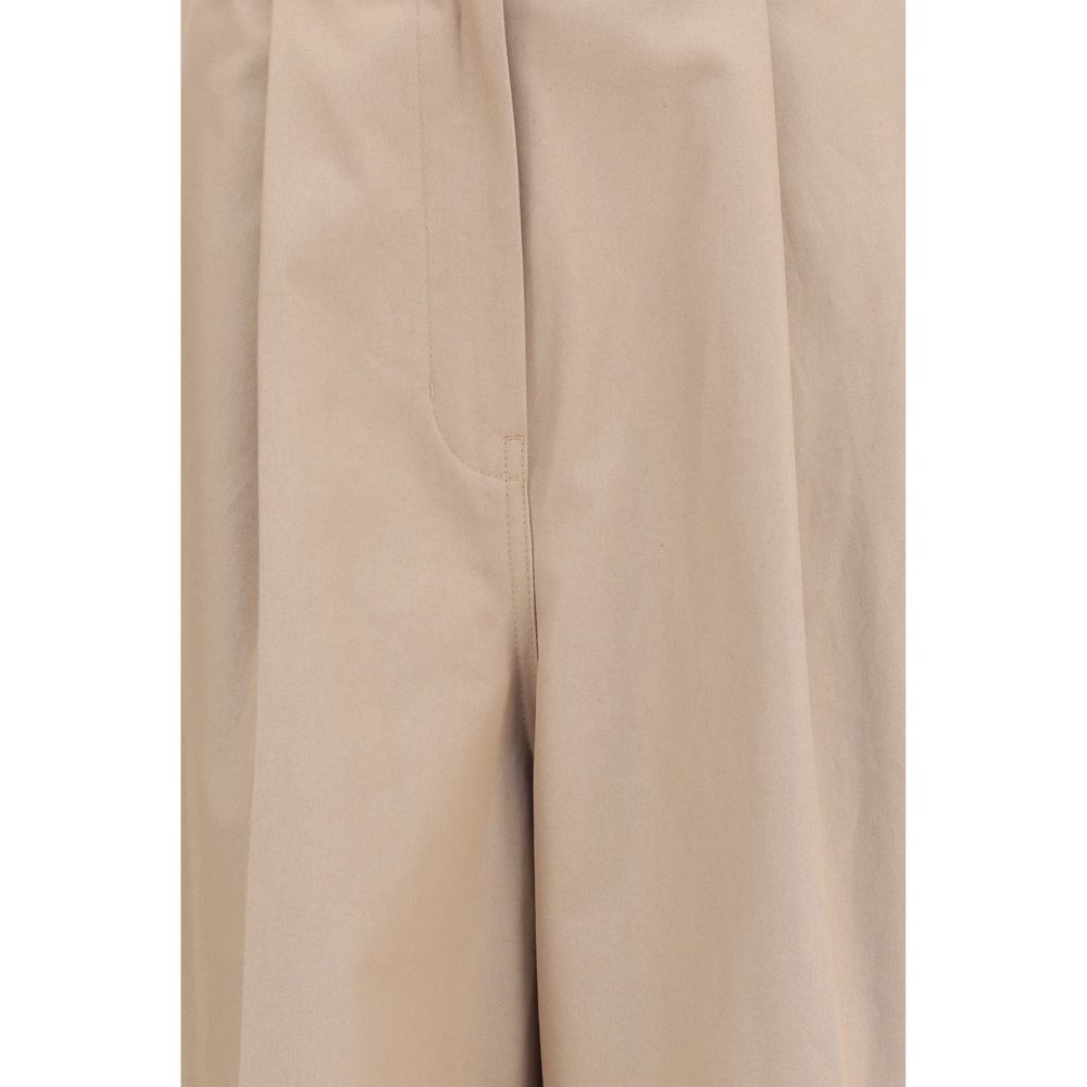 Pantalons évasés en coton beige de Balenciaga, style décontracté avec coupe fluide et détails modernes.
