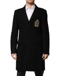 Veste Dolce & Gabbana noire à patch héraldique, croisée simple, avec détails élégants et finition raffinée.