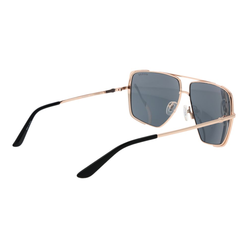 Lunettes de soleil en métal or rose Guess, style élégant, avec monture fine et verres teintés, pour un look tendance.
