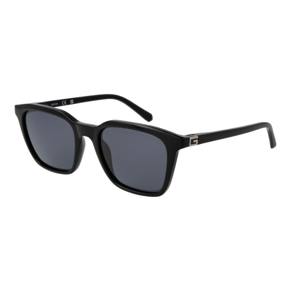 Lunettes de soleil en plastique noir Guess avec monture rectangulaire et verres foncés, mode et protection solaire élégante.