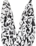 Robe longue sans manches noir et blanc Dolce & Gabbana avec logo, longueur au sol, élégante et sophistiquée.