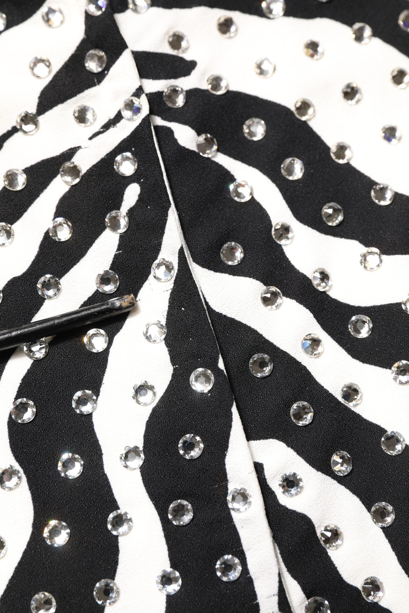 Robe Dolce & Gabbana noire et blanche à motif zèbre avec cristaux ornant le tissu, élégante et sophistiquée.