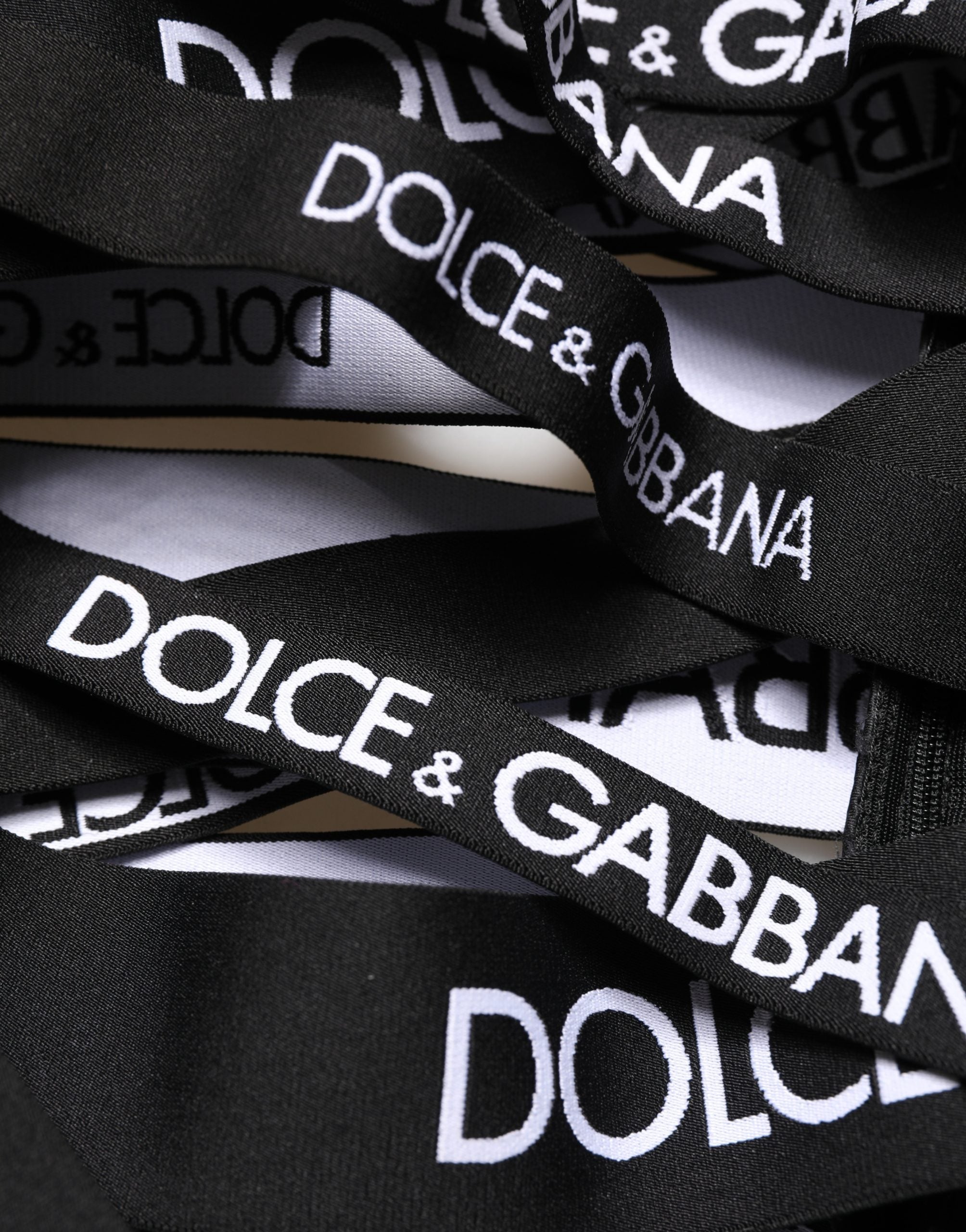 Pantalon skinny taille haute noir Dolce & Gabbana avec logo et découpes, style moderne et élégant.