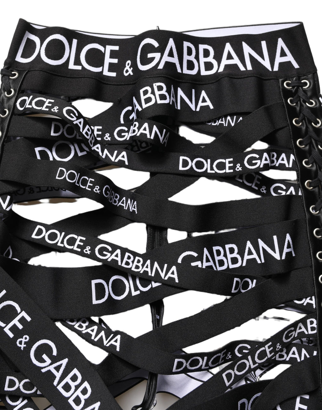 Pantalons skinny taille haute noirs Dolce & Gabbana avec bande logo, découpes et design élégant.