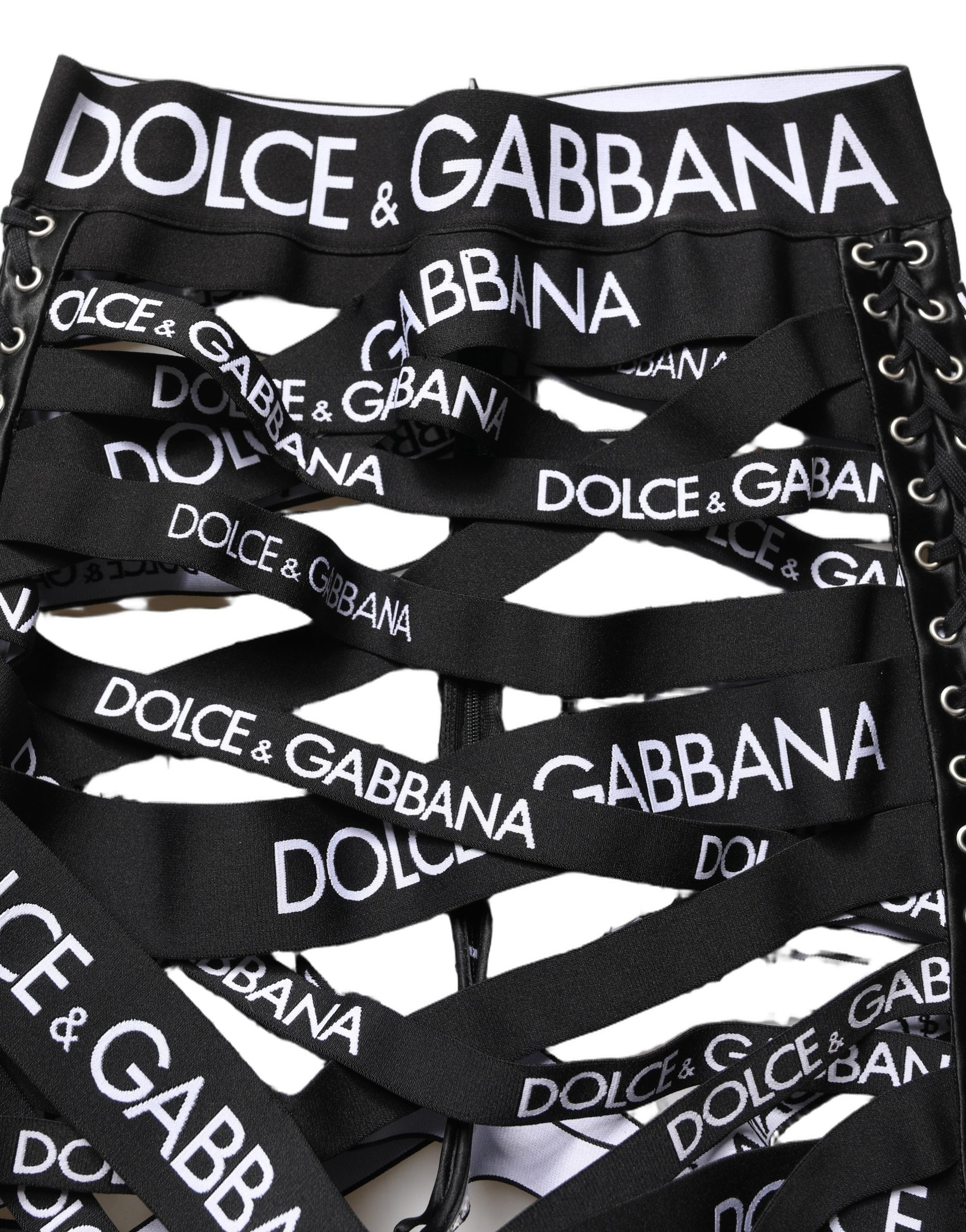 Pantalons skinny taille haute noirs Dolce & Gabbana avec bande logo, découpes et design élégant.