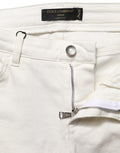 Jeans skinny en coton blanc déchiré de Dolce & Gabbana, style décontracté avec détails usés et coupe ajustée.