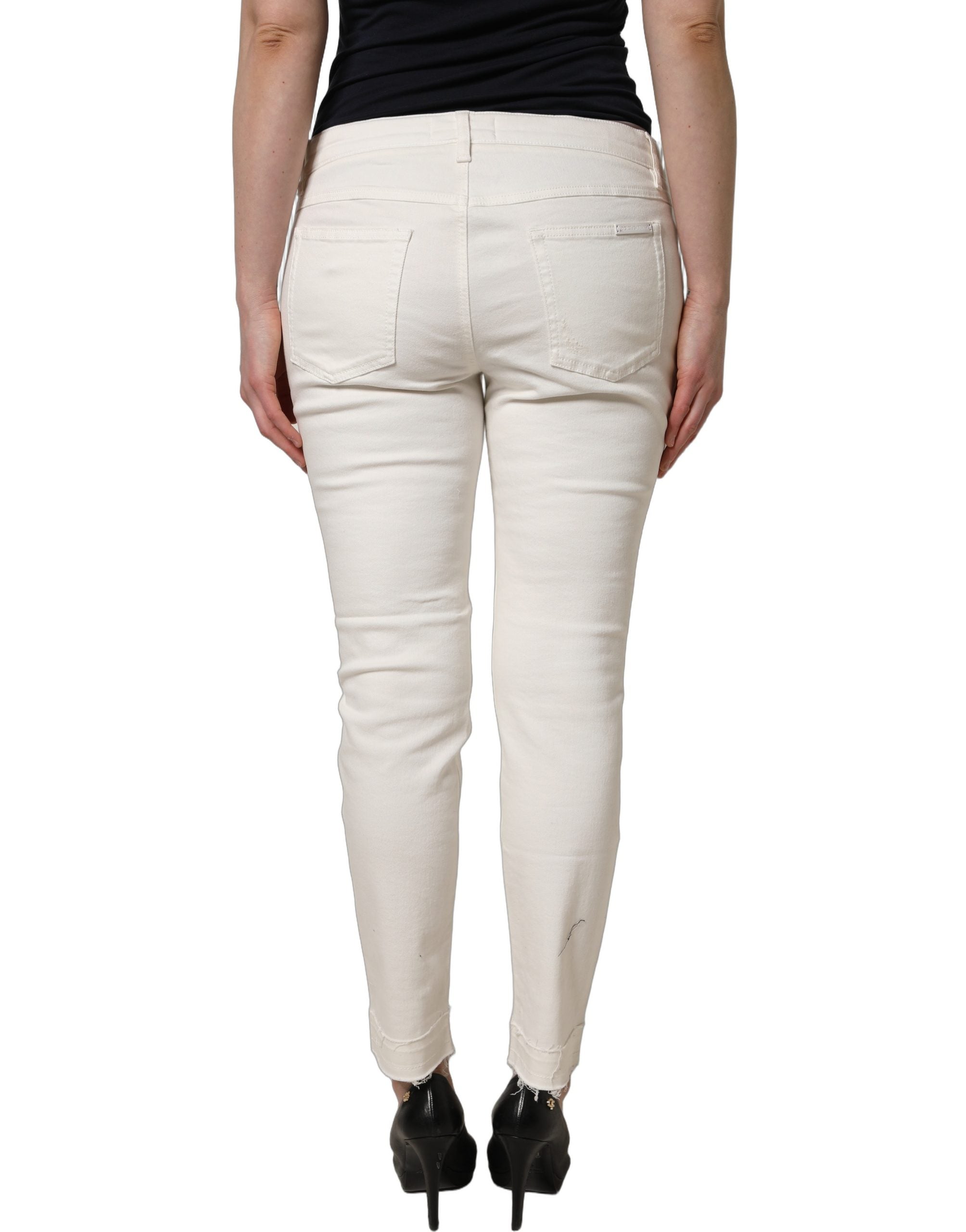 Jeans skinny en coton déchiré blanc Dolce & Gabbana, style tattered, denim élégant avec détails usés, vue de face.