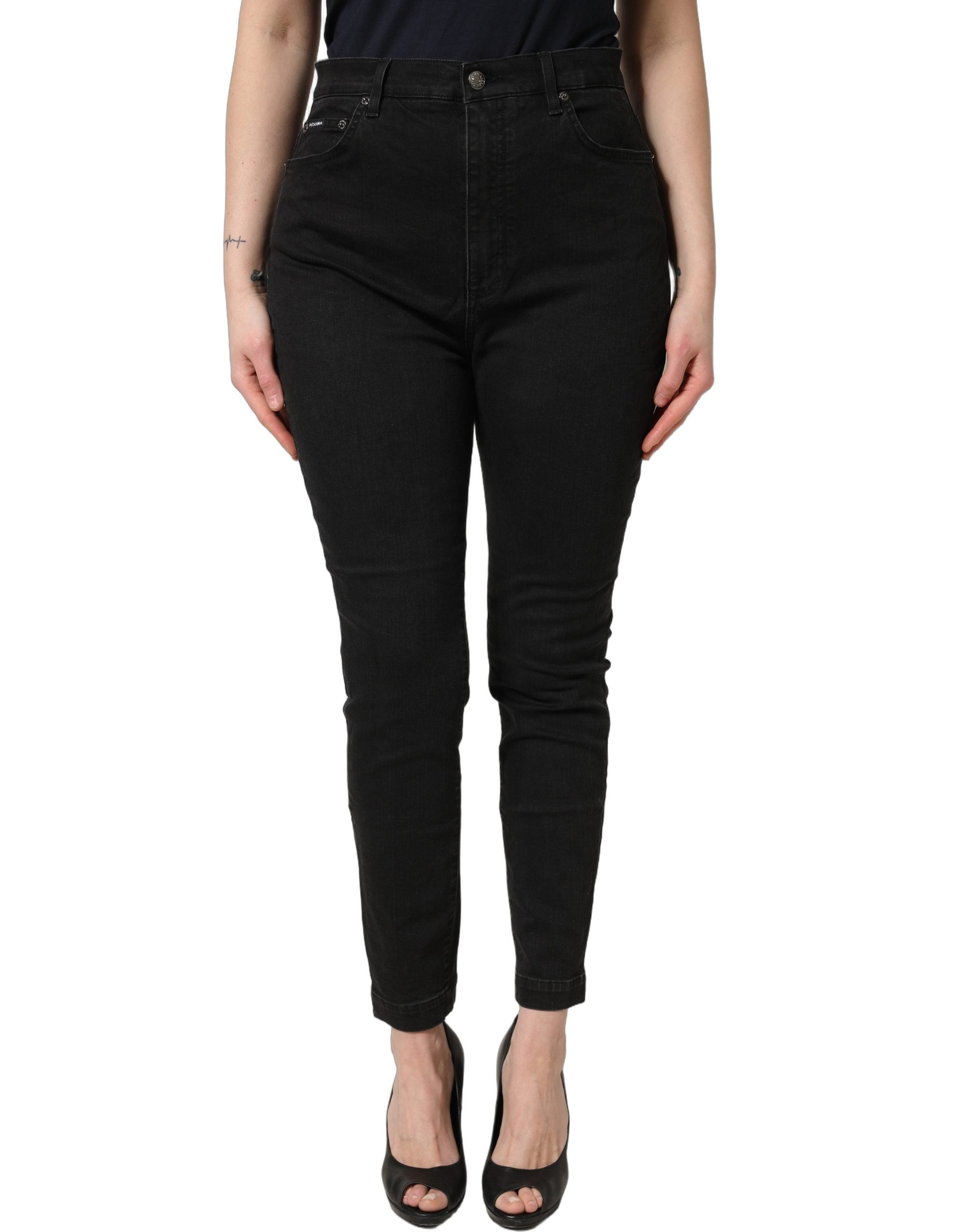 Jeans skinny en coton noir Dolce & Gabbana à taille haute, visible avec détails de couture et coupe ajustée.