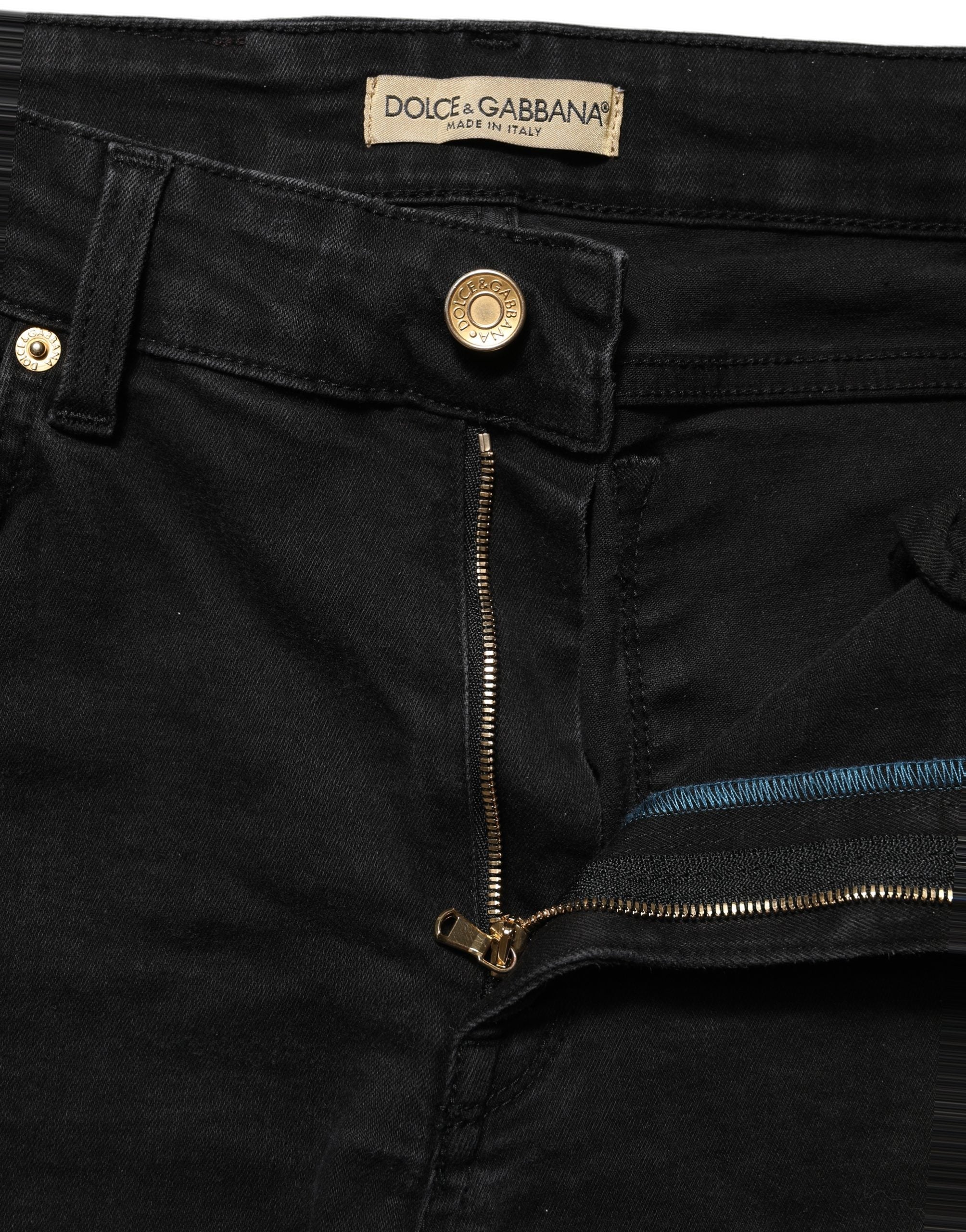 Jeans skinny en denim noir Dolce & Gabbana en coton à taille basse, montrant la coupe ajustée et la texture du tissu.