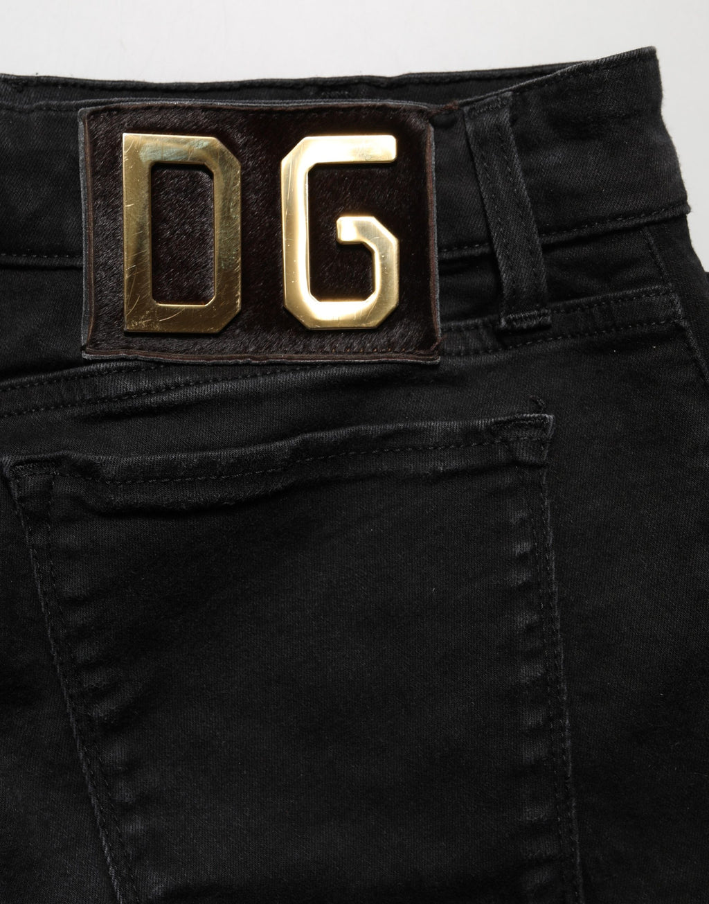 Jeans skinny noirs en coton à taille basse de Dolce & Gabbana, montrant la coupe ajustée et la texture denim.