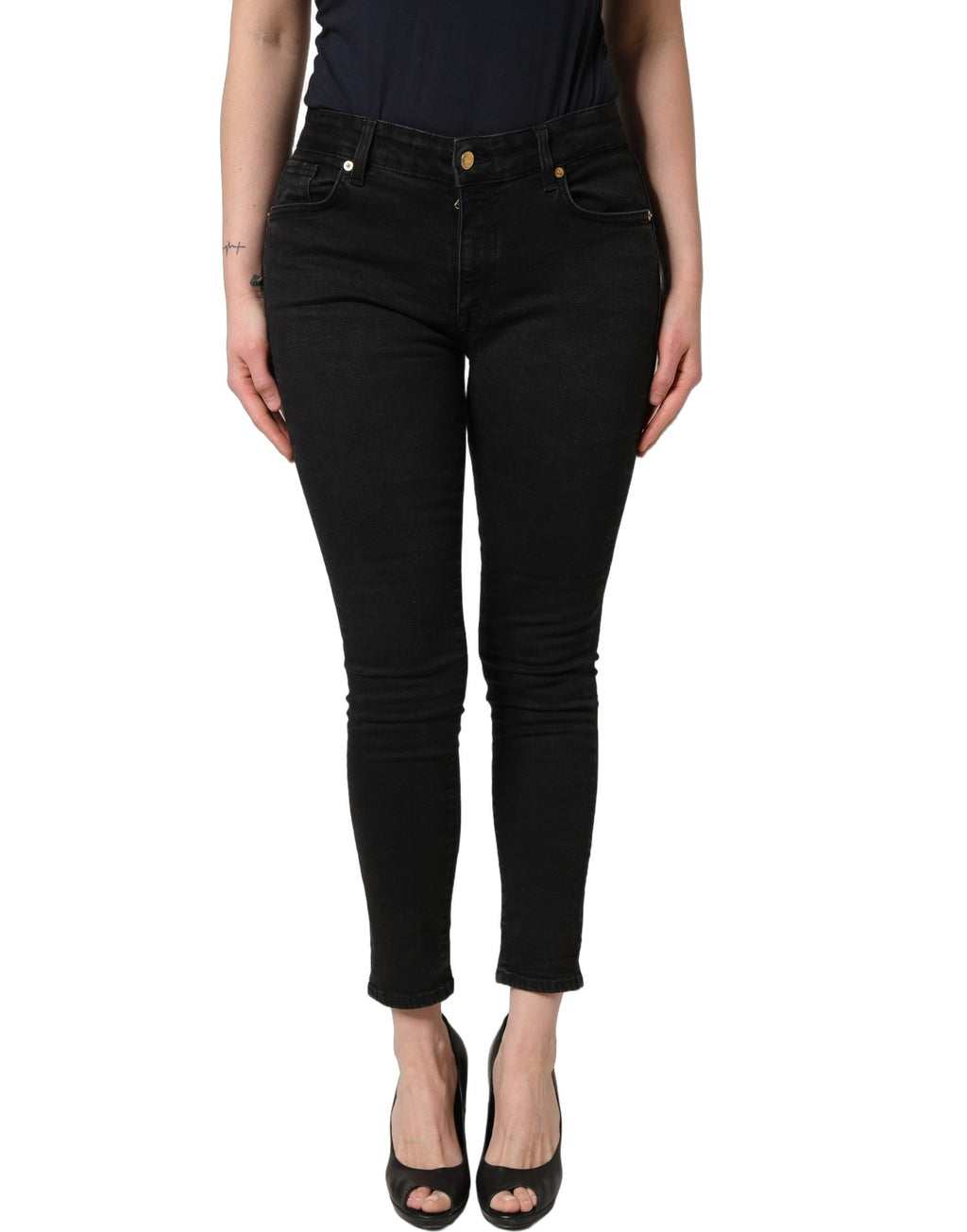 Jeans skinny noirs en coton Dolce & Gabbana avec taille basse, visibles sur un mannequin.