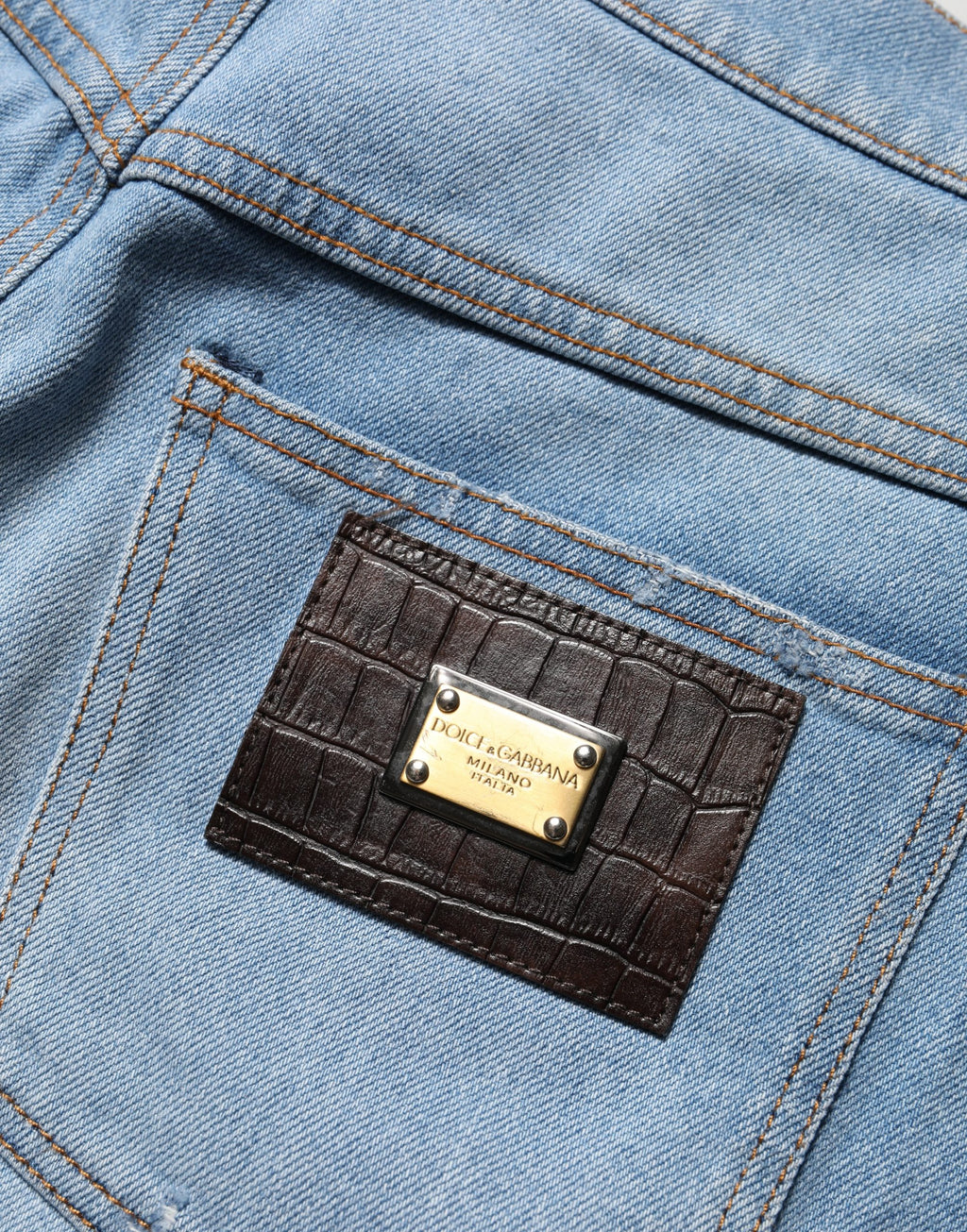 Jeans en denim coton bleus distressed à plis de Dolce & Gabbana, style décontracté et tendance.