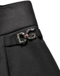 Pantalon en laine noire Dolce & Gabbana à taille haute avec logo, style chic et élégant, visible avec une coupe ajustée.