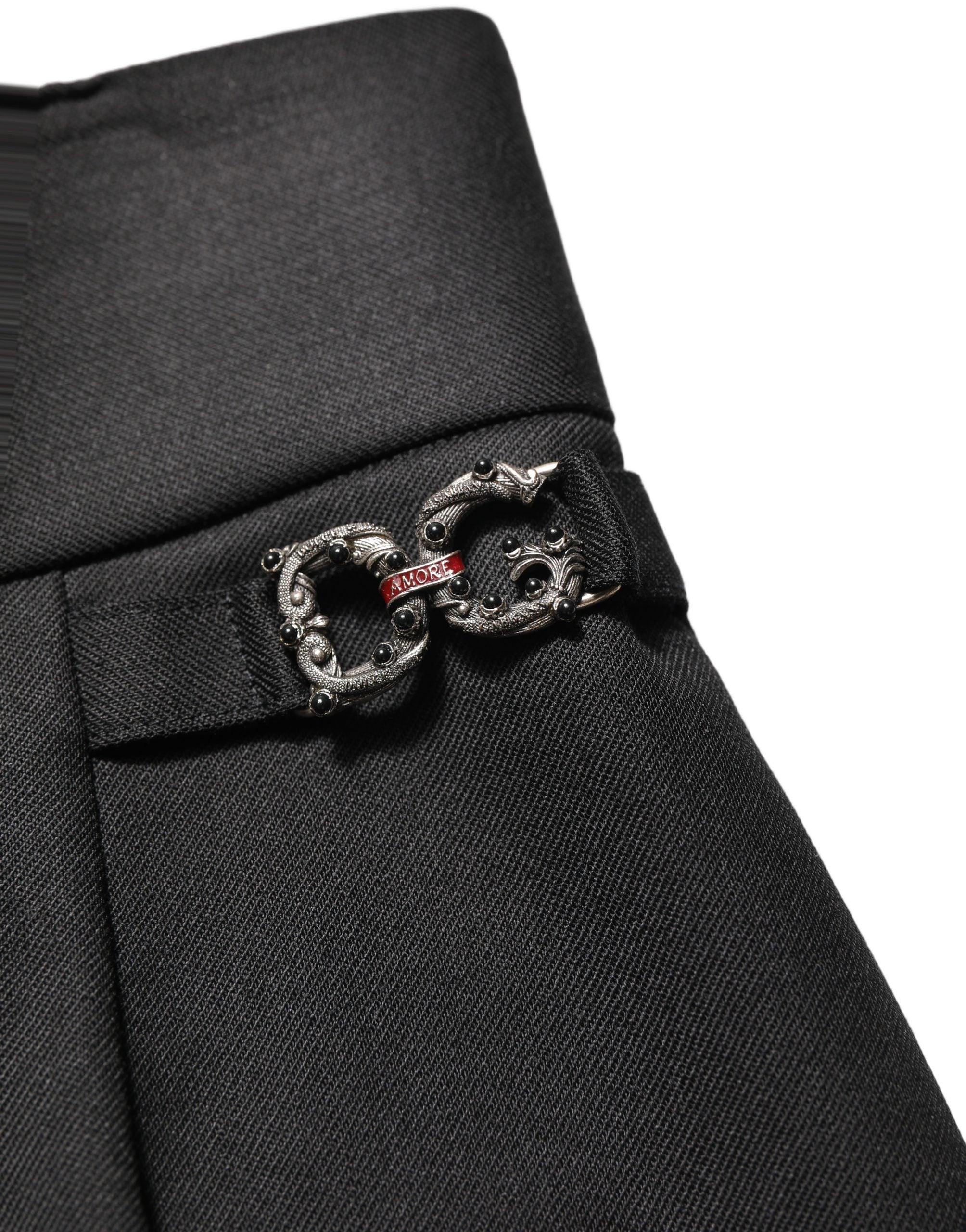 Pantalon en laine noire Dolce & Gabbana à taille haute avec logo, style chic et élégant, visible avec une coupe ajustée.