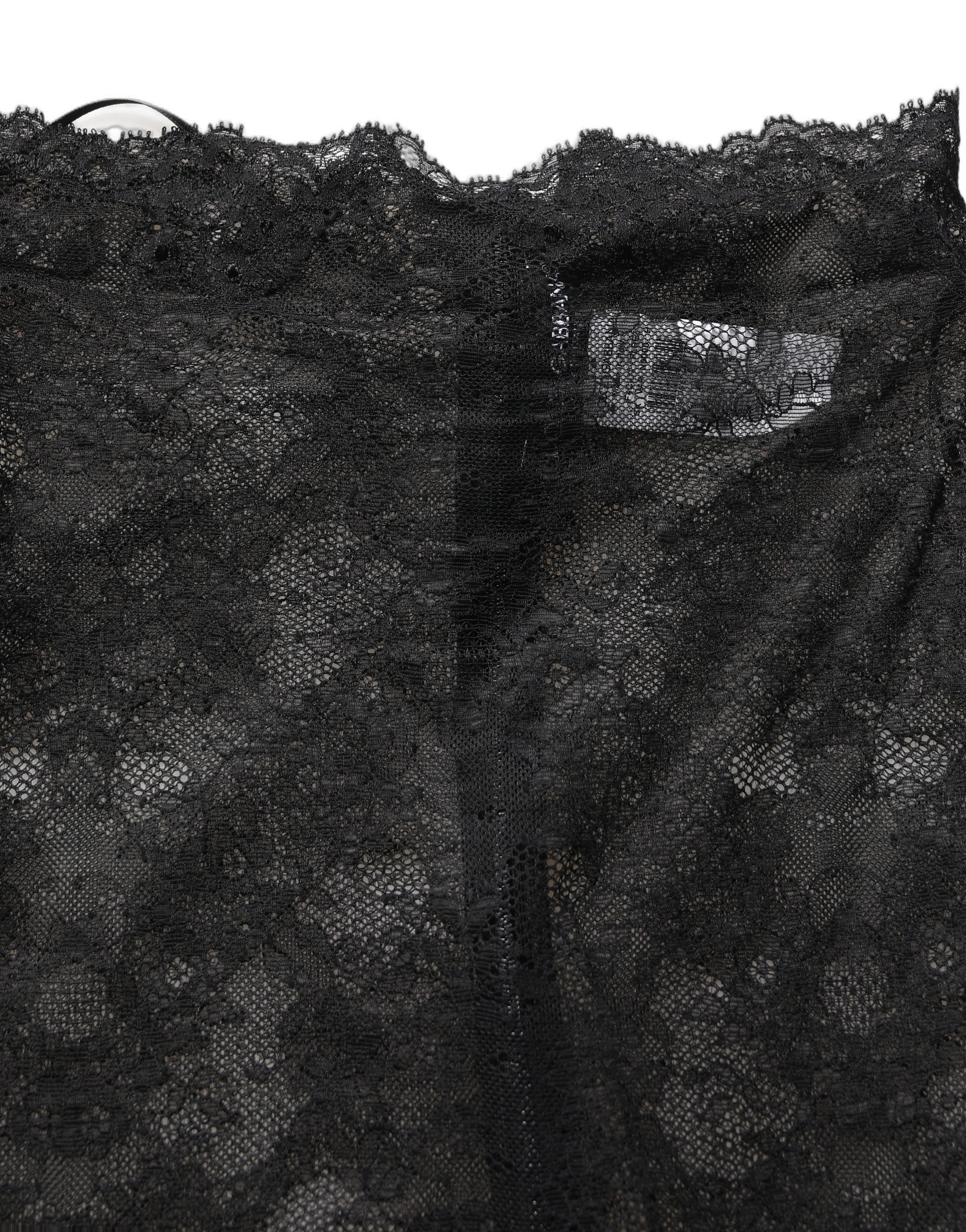 Jupe longue blanche à fleurs en dentelle noire de Dolce & Gabbana, taille haute, longueur genou, élégante et sophistiquée.