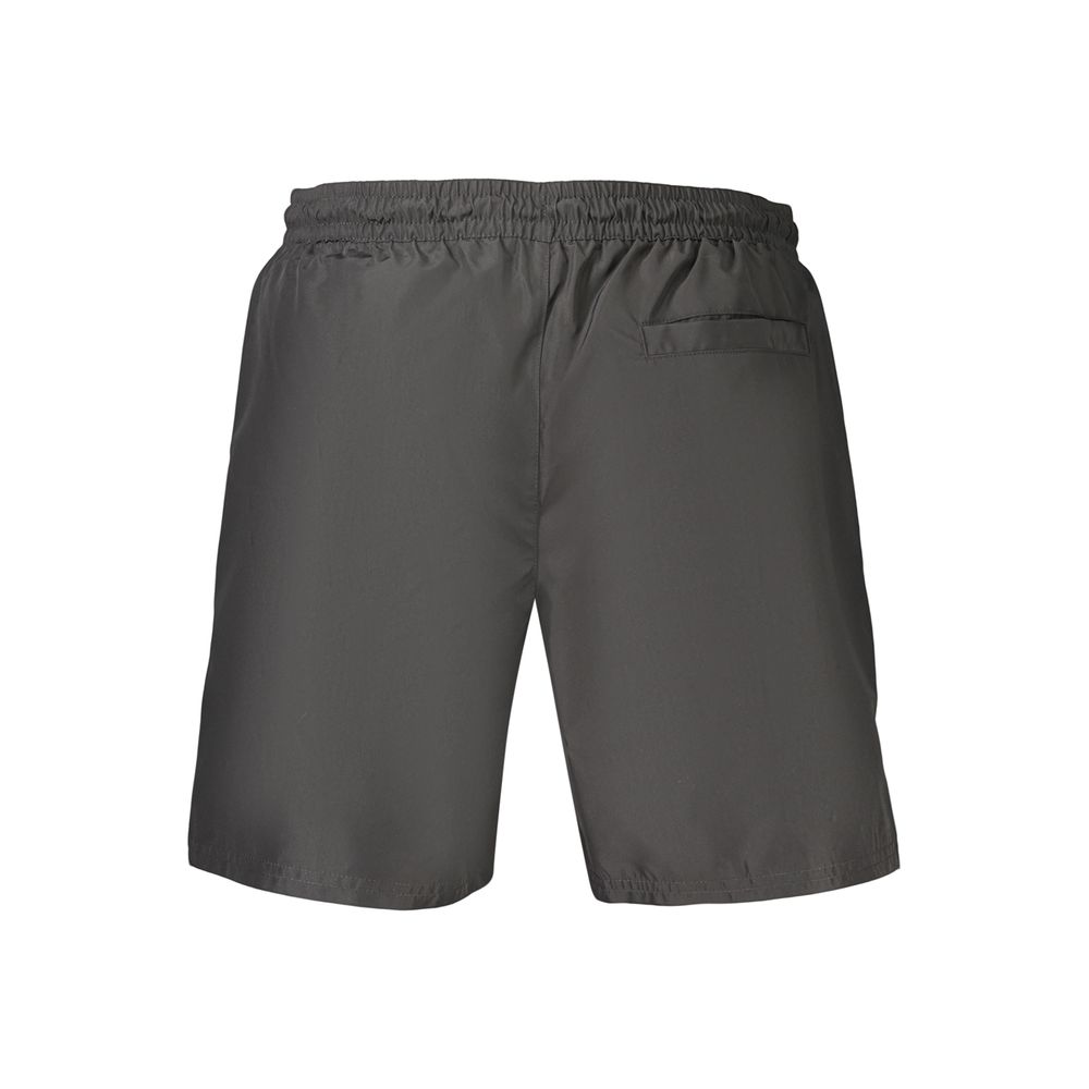 Shorts de bain pour homme Calvin Klein en polyester noir, coupe classique et design épuré, parfait pour la plage ou la piscine.