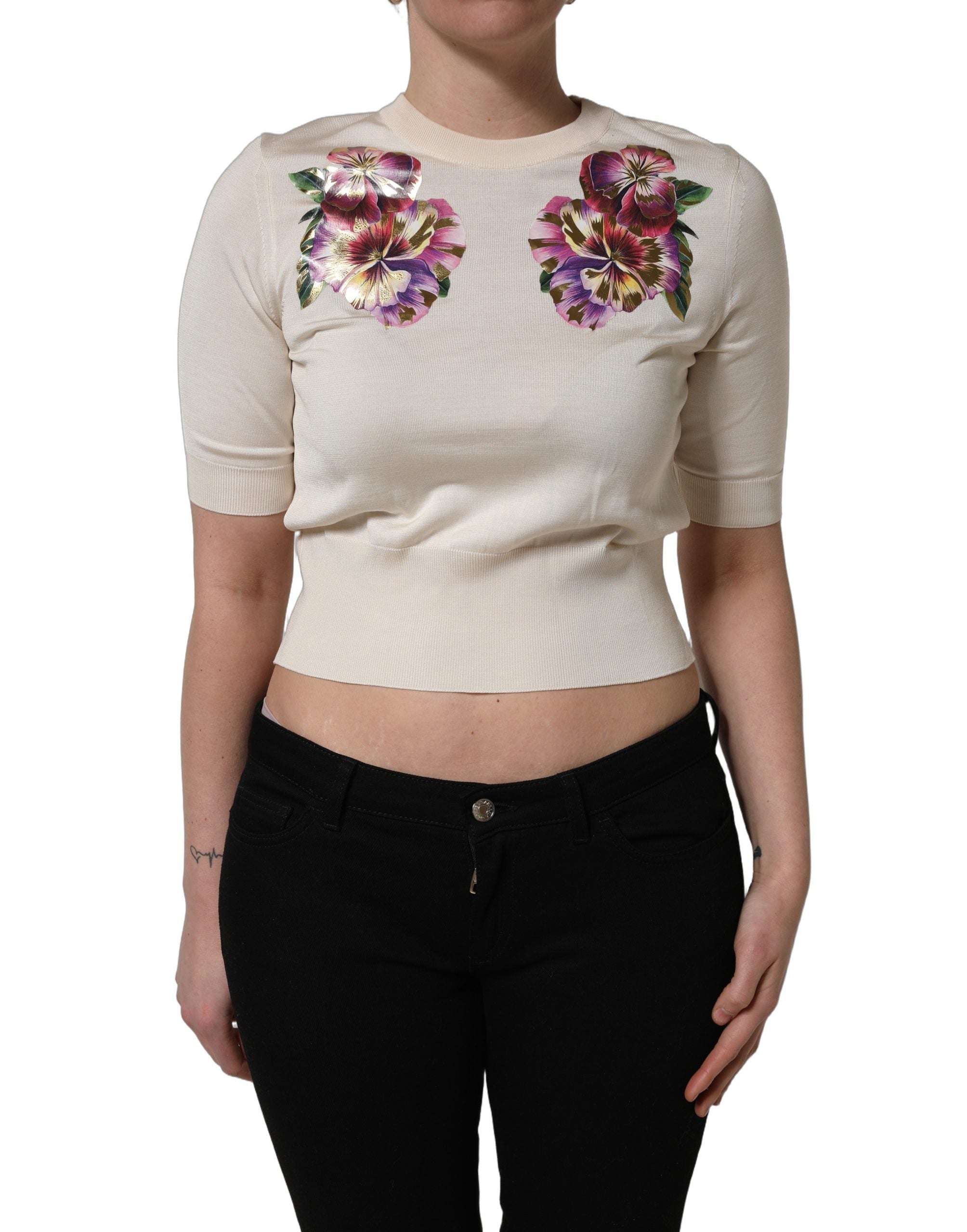 Pull-over en soie beige à fleurs Dolce & Gabbana, col rond, avec motif floral élégant visible sur l'image.