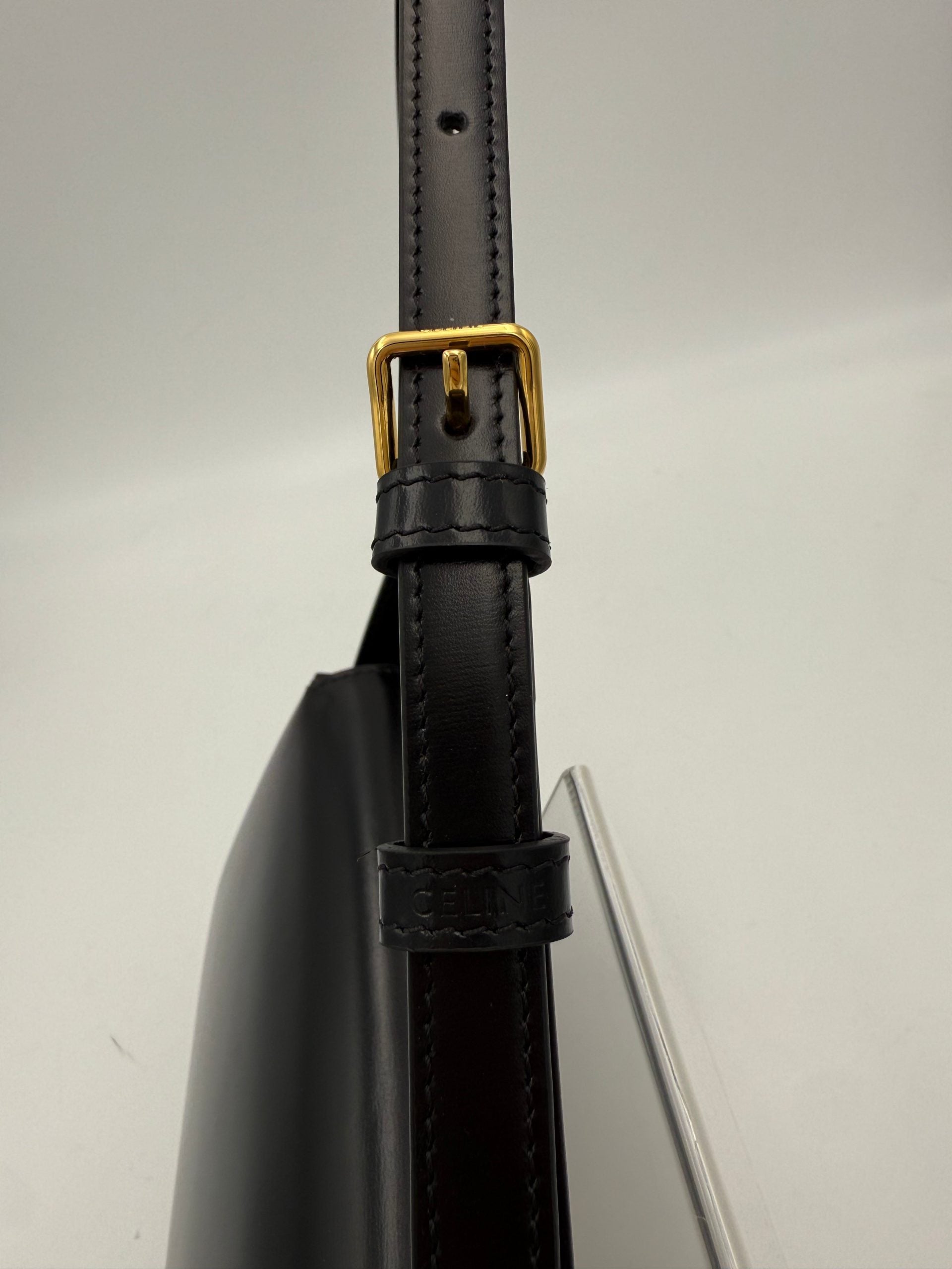 Sac à main noir Celine Claude Triomphe, en cuir avec logo emblématique, élégant et sophistiqué, vue de face.