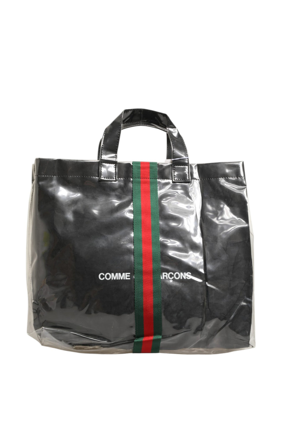 Sac Gucci GG x Comme des Garçons en toile avec logo, grand sac cabas, design distinctif et logo imprimé visible.