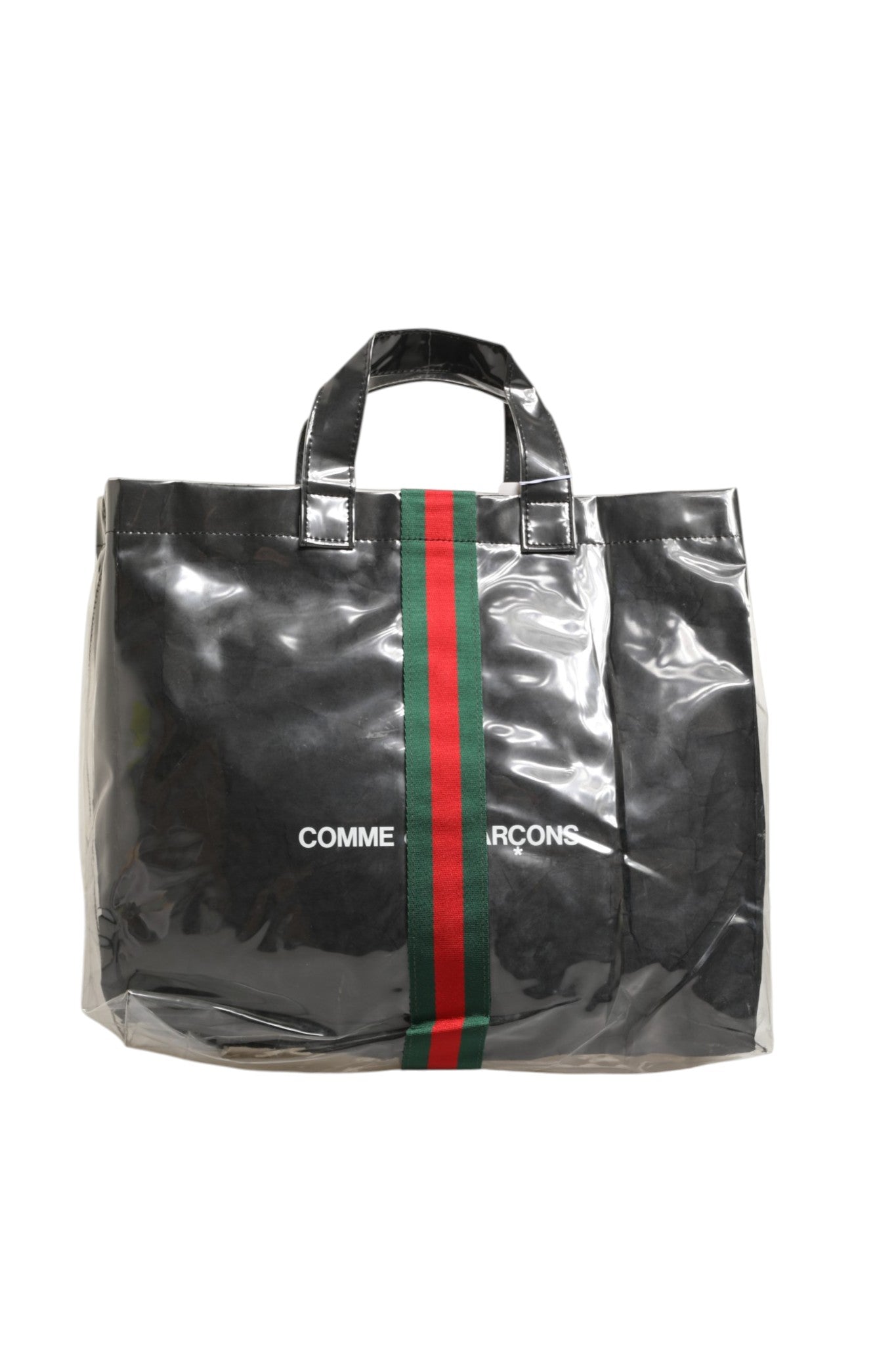Sac Gucci GG x Comme des Garçons en toile avec logo, grand sac cabas, design distinctif et logo imprimé visible.