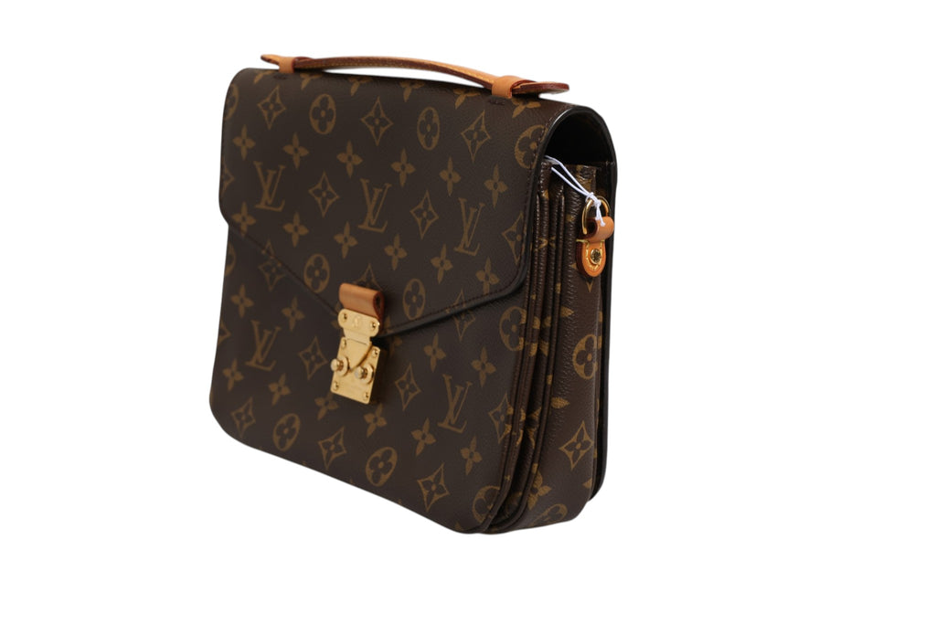 Sac pochette Métis Louis Vuitton en toile monogramme, avec poignée en cuir et fermeture éclair visible.