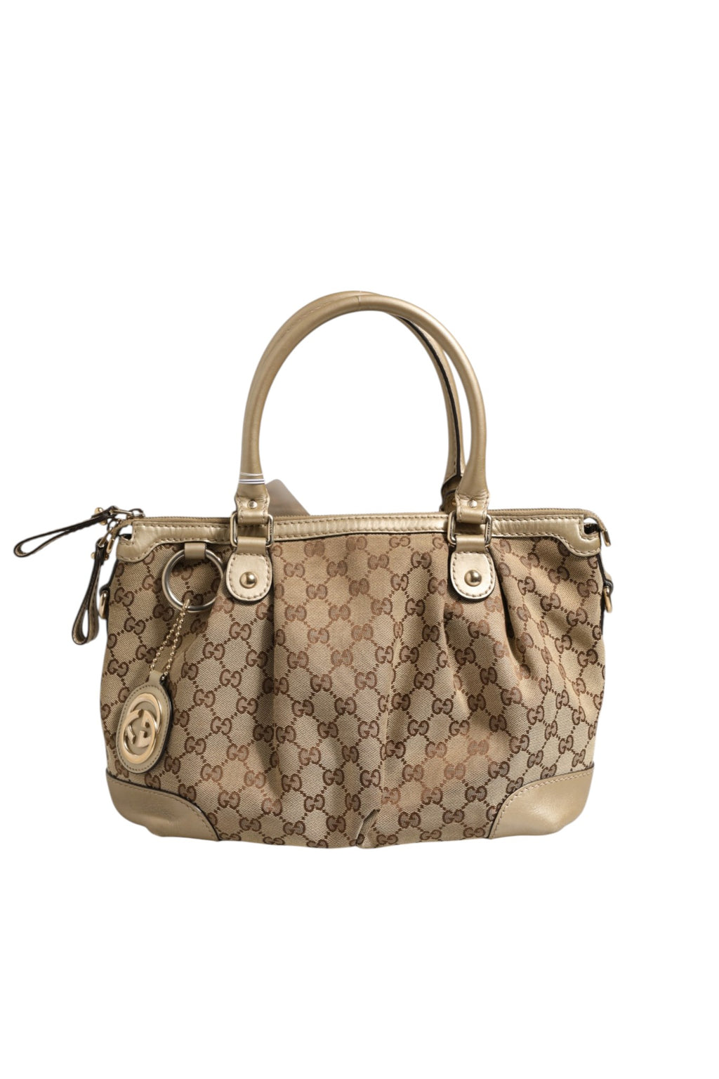 Sac Gucci Sukey en toile 2 voies, avec poignées en cuir et logo Gucci, placé sur un fond neutre.