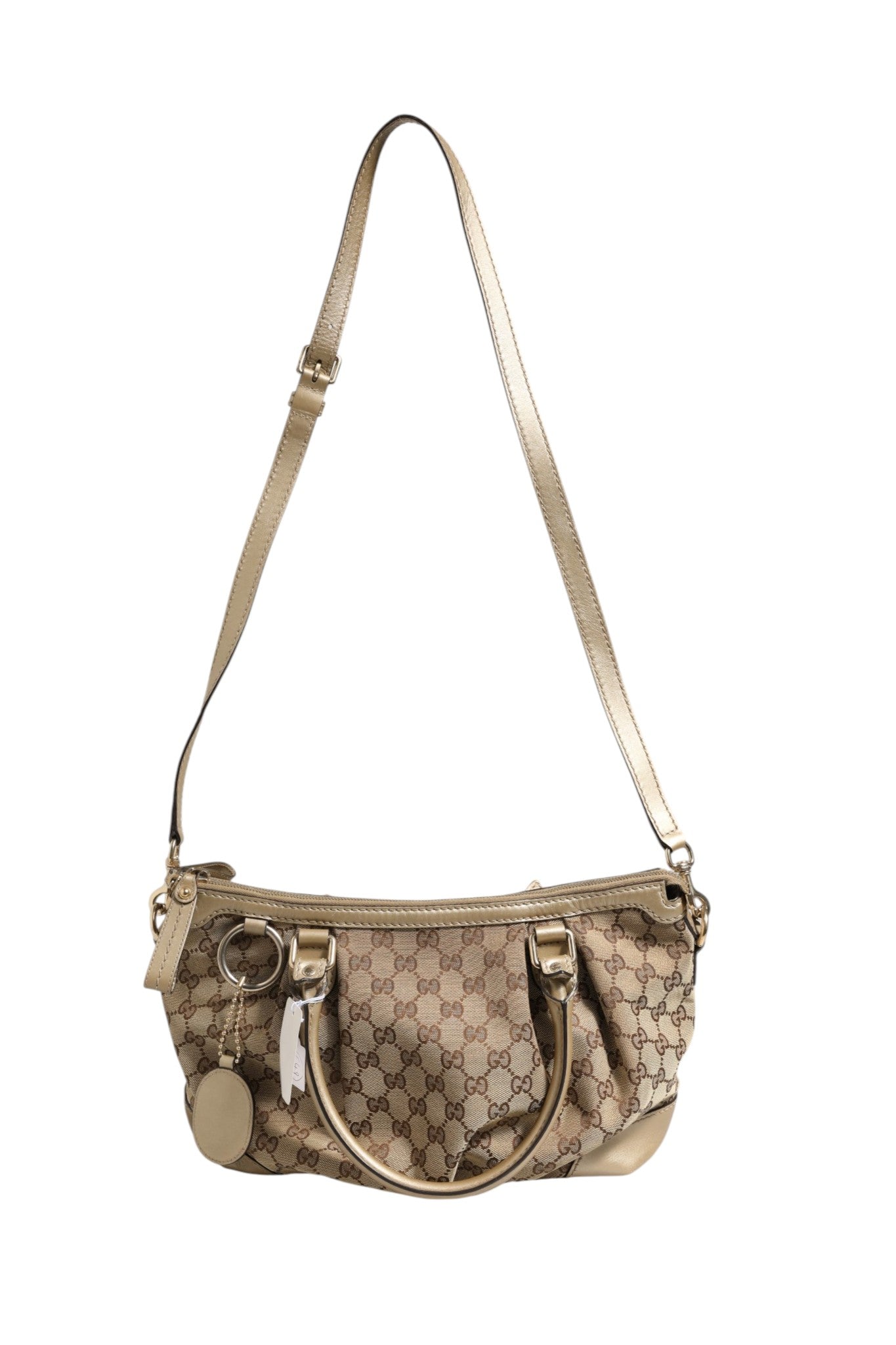 Sac à main Gucci Sukey Canvas 2 voies avec poignées et bandoulière, en toile avec logo Gucci visible.