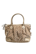 Sac à main Gucci Canvas Sukey Satchel avec bandoulière en toile et détails en cuir, logo Gucci visible.